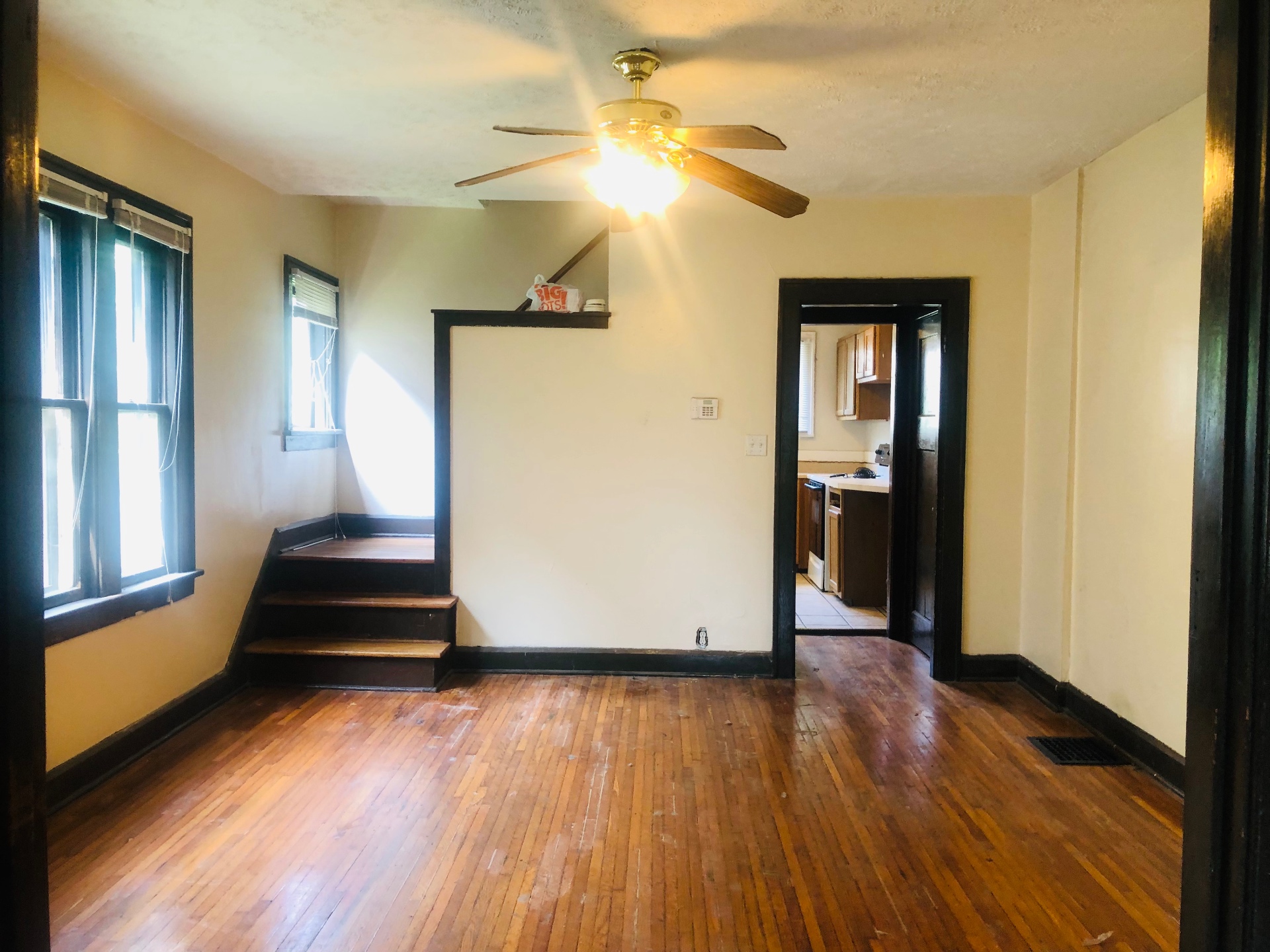 2155 N 4th St. dining area with hardwood floors and stair landing to kitchen