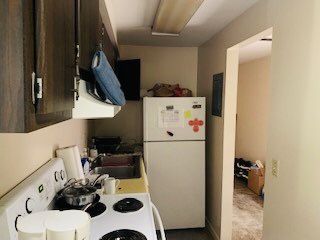 2026 Summit St. kitchen with electric range, fridge, and view into carpeted living area