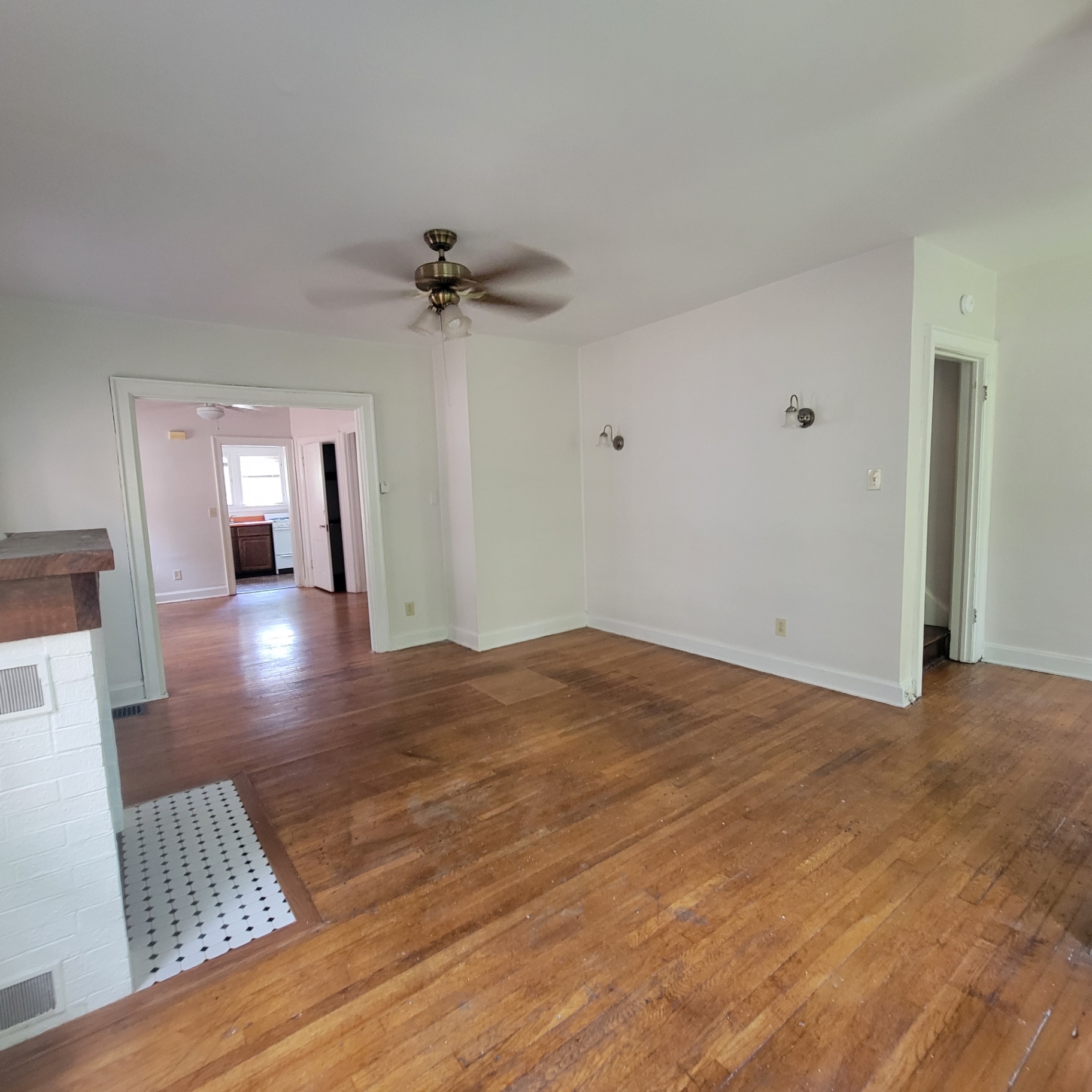 2048 Iuka Ave. C living room view toward kitchen with wall sconces and ceiling fan