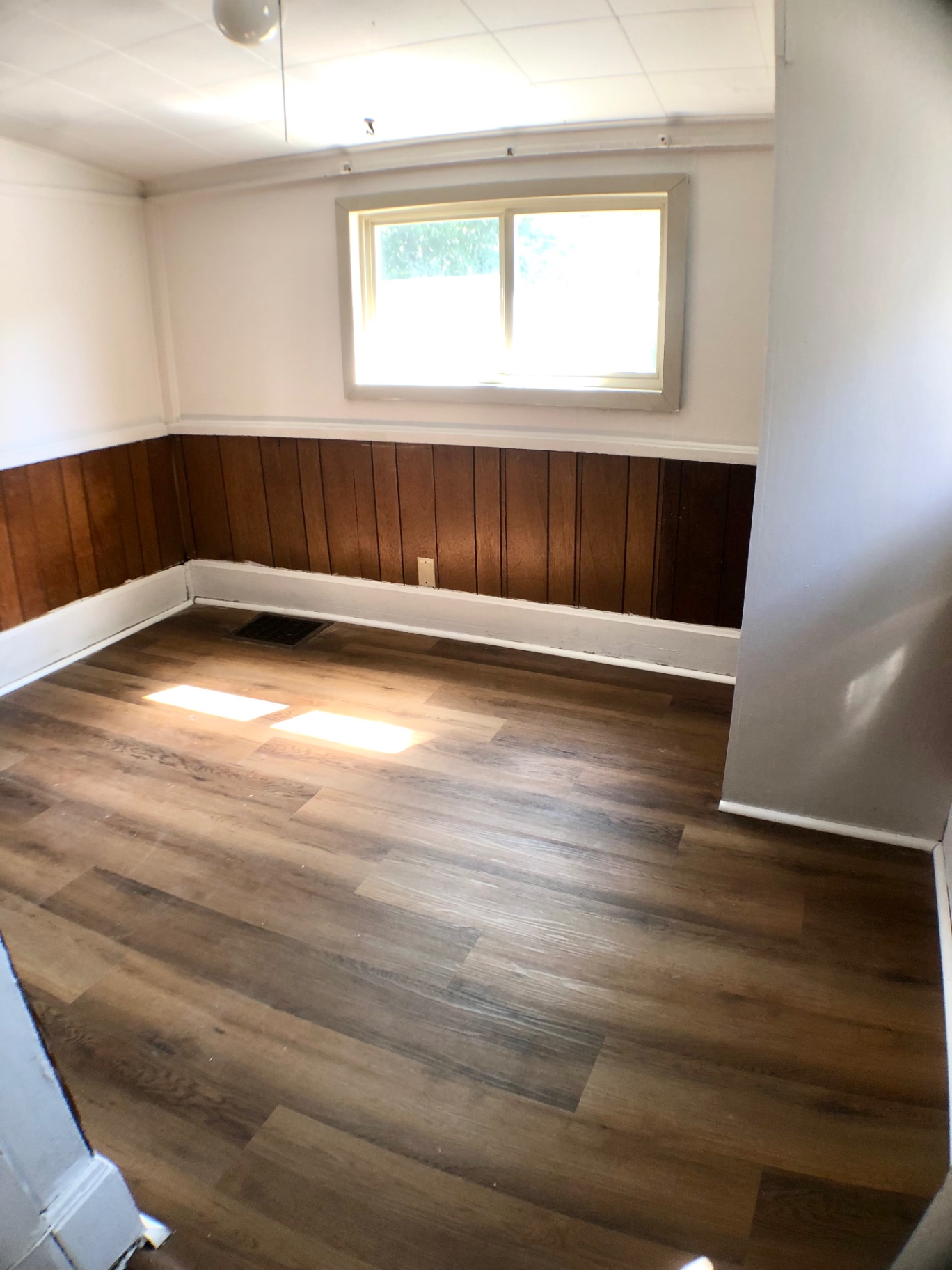 1814 Summit St. bonus room with wood wainscoting and updated vinyl plank flooring