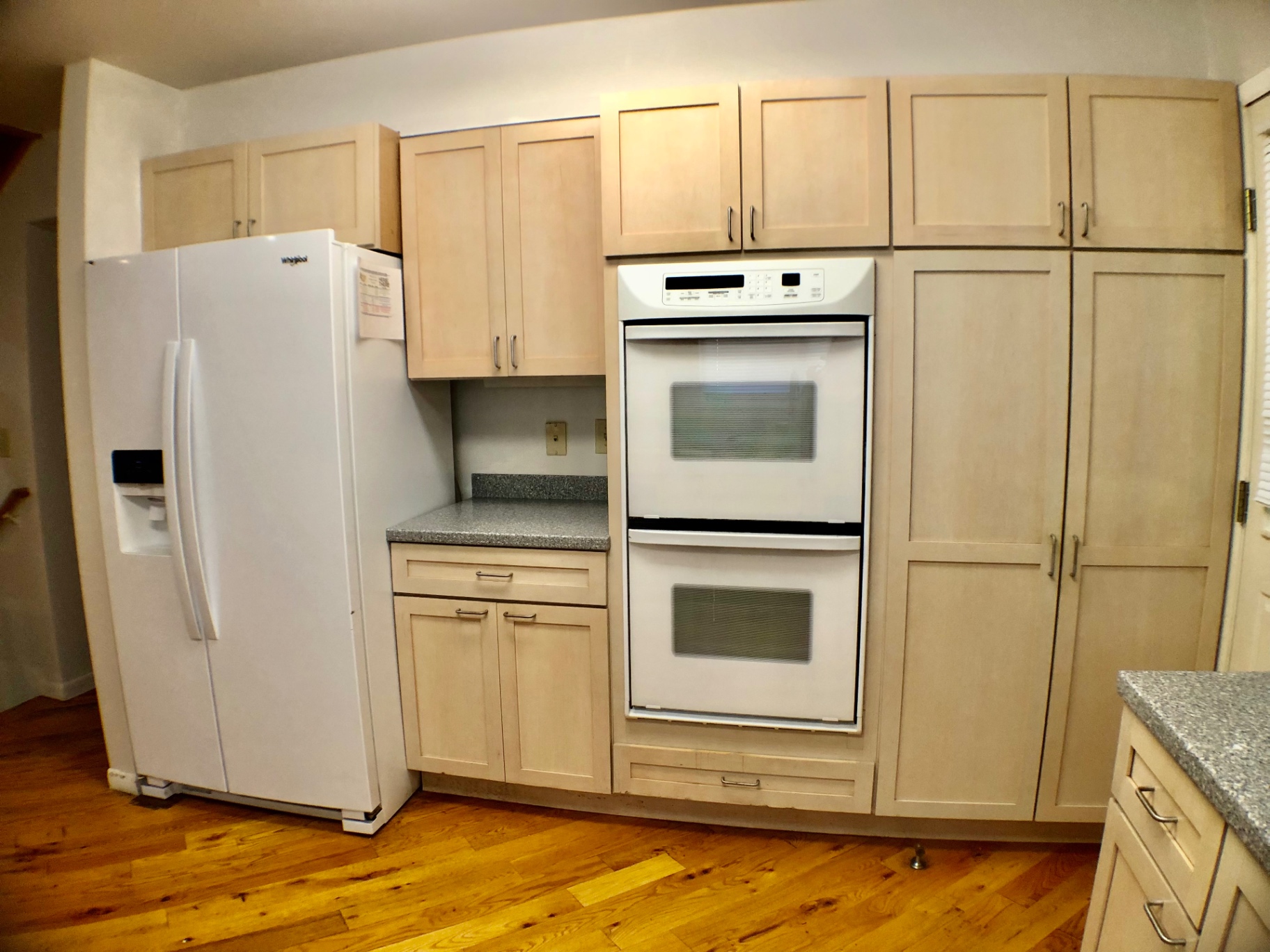 2040 Iuka Ave House kitchen with side-by-side fridge, double wall oven, and full-height pantry cabinets