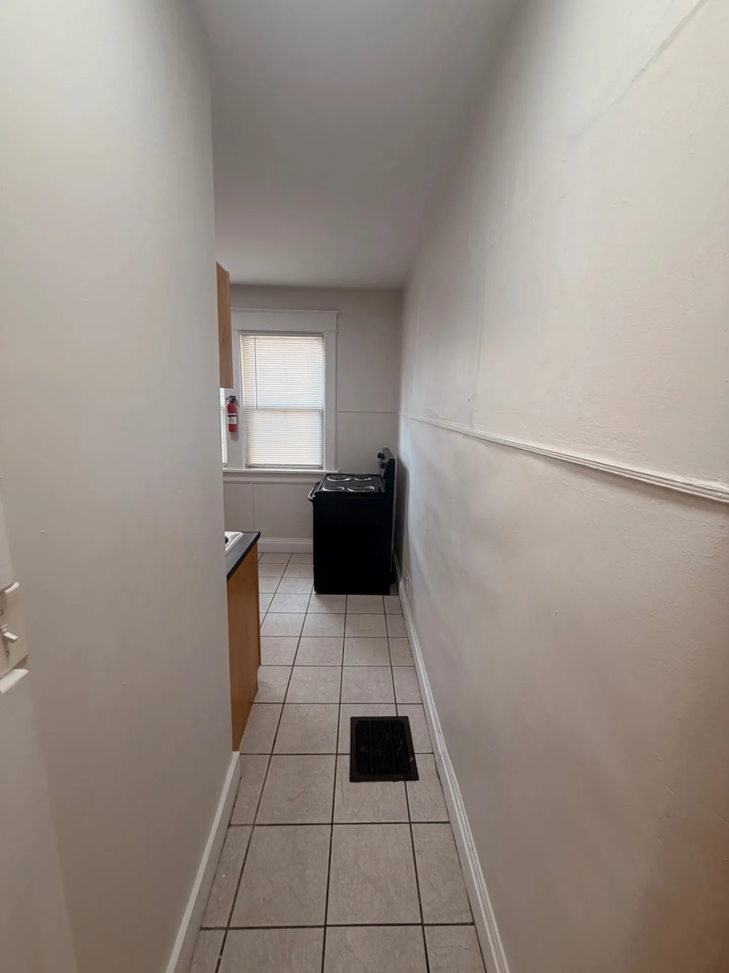 1816 Summit St. galley kitchen view with tile floors and window