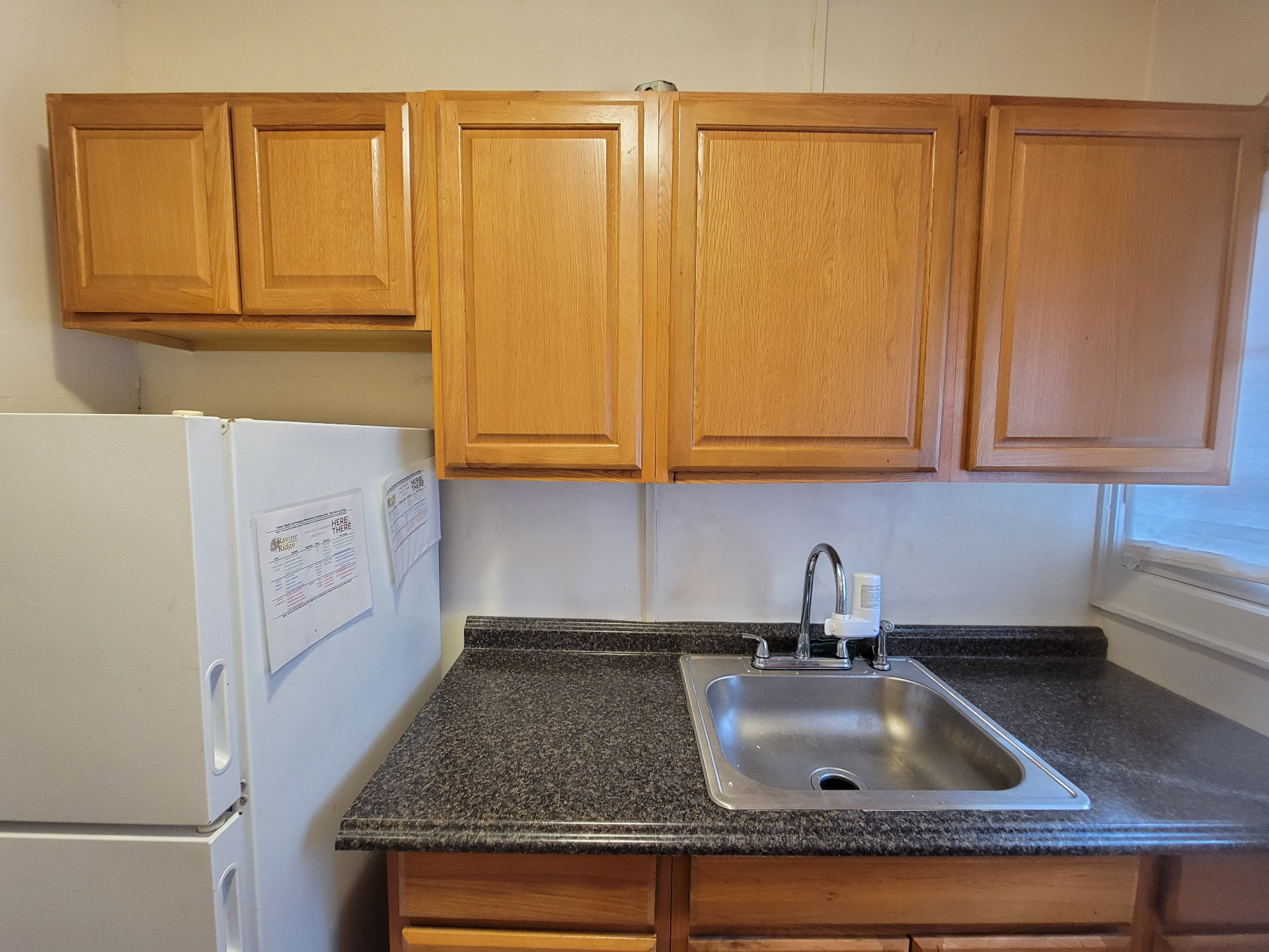 2048 Iuka Ave. B kitchen with stainless sink, granite-look counters, and abundant cabinet storage