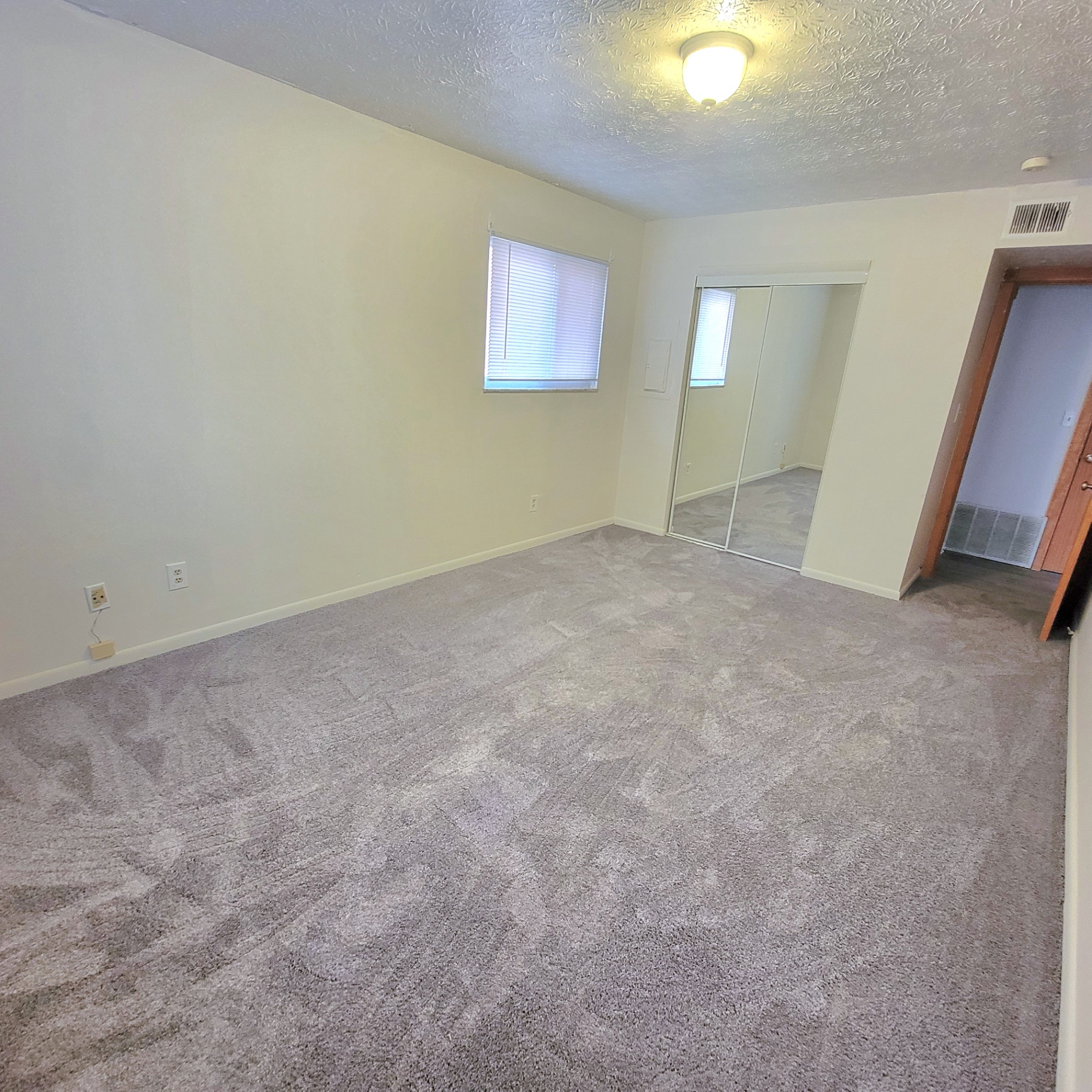 2150 N 4th St. Unit D second bedroom with mirrored closet and plush carpet
