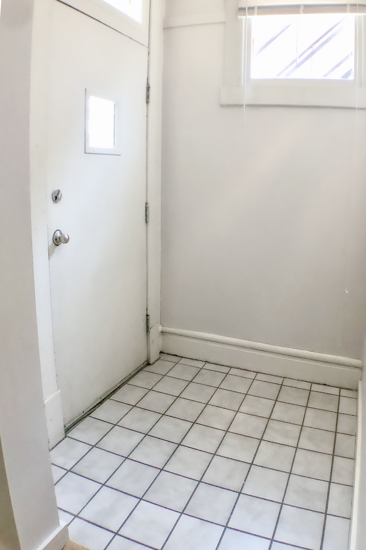 Unit A back entry with tile floor and private door