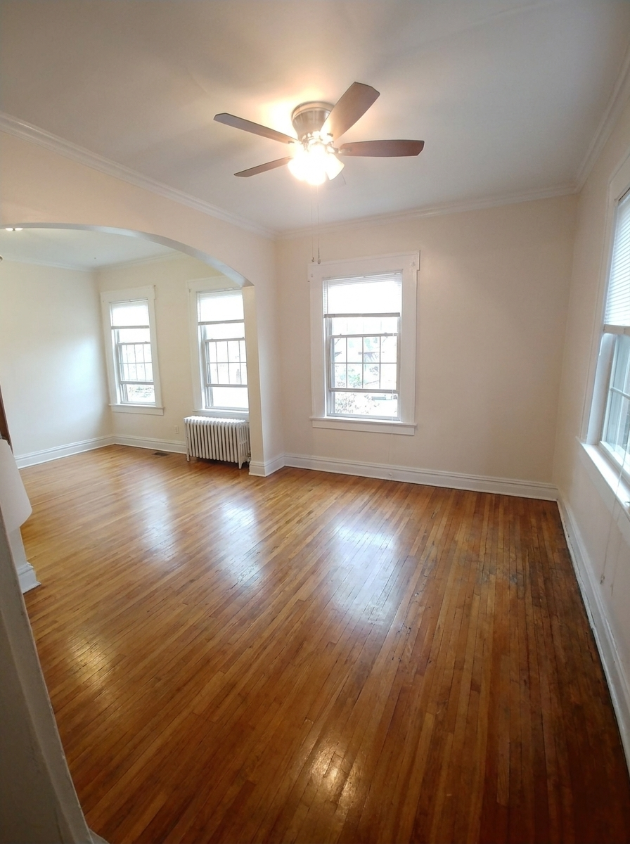 Unit C dining room with archway opening and radiator