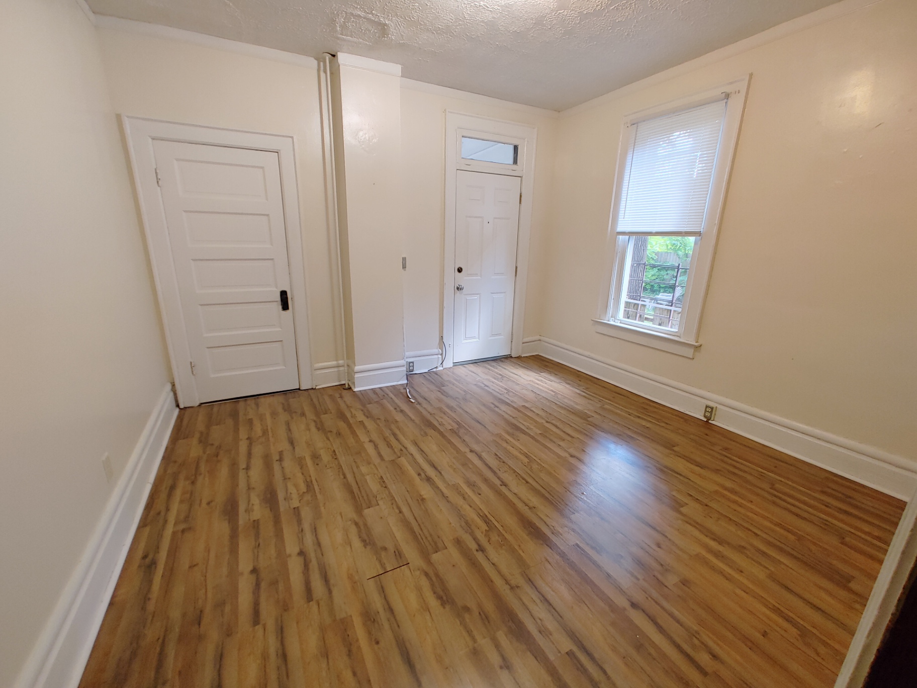 374 A E 14th Ave. bedroom with plank flooring, back door, and bright window