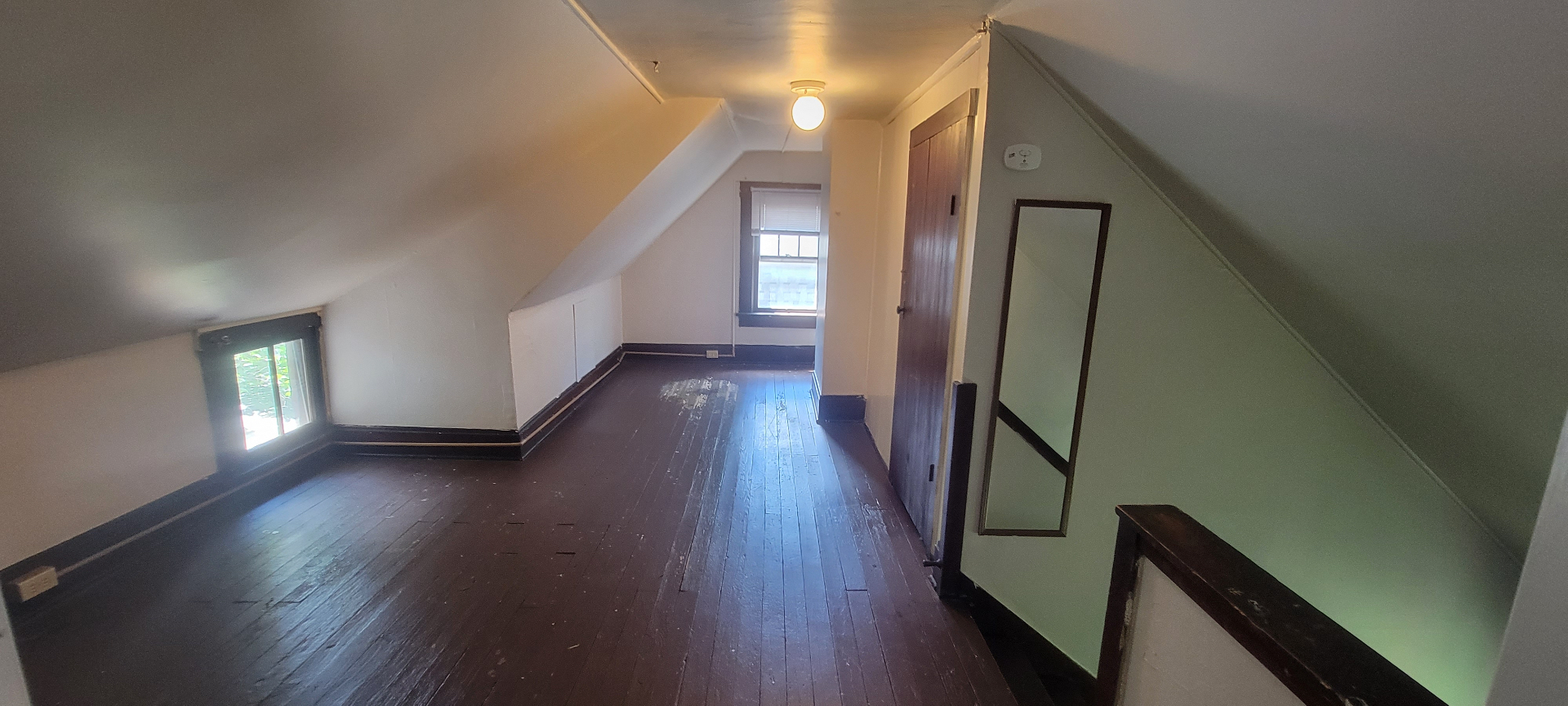 2015 Summit St. third-floor hallway with sloped ceilings, hardwood floors, and mirror