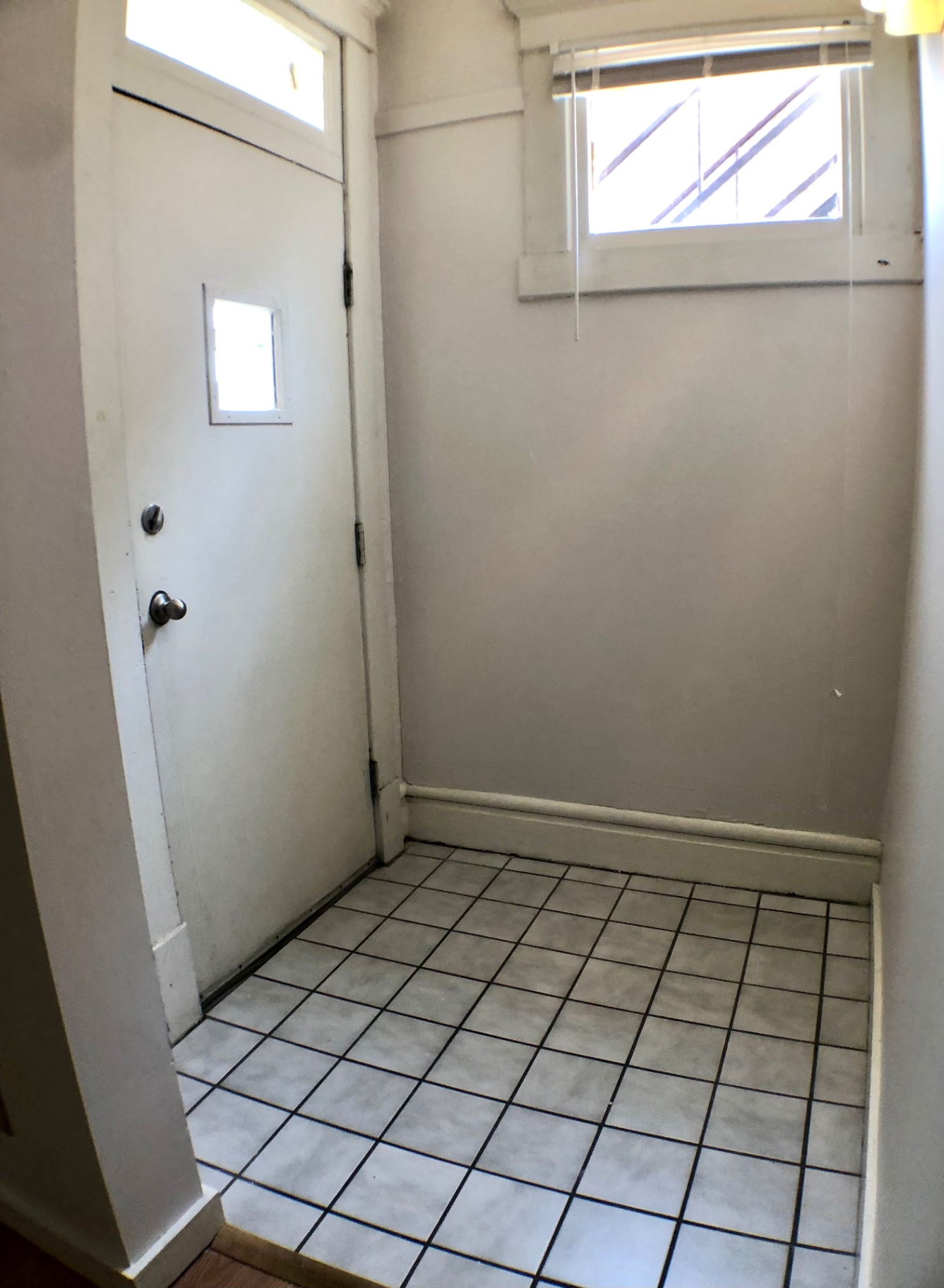 Unit A mudroom entry with tile floor and transom window