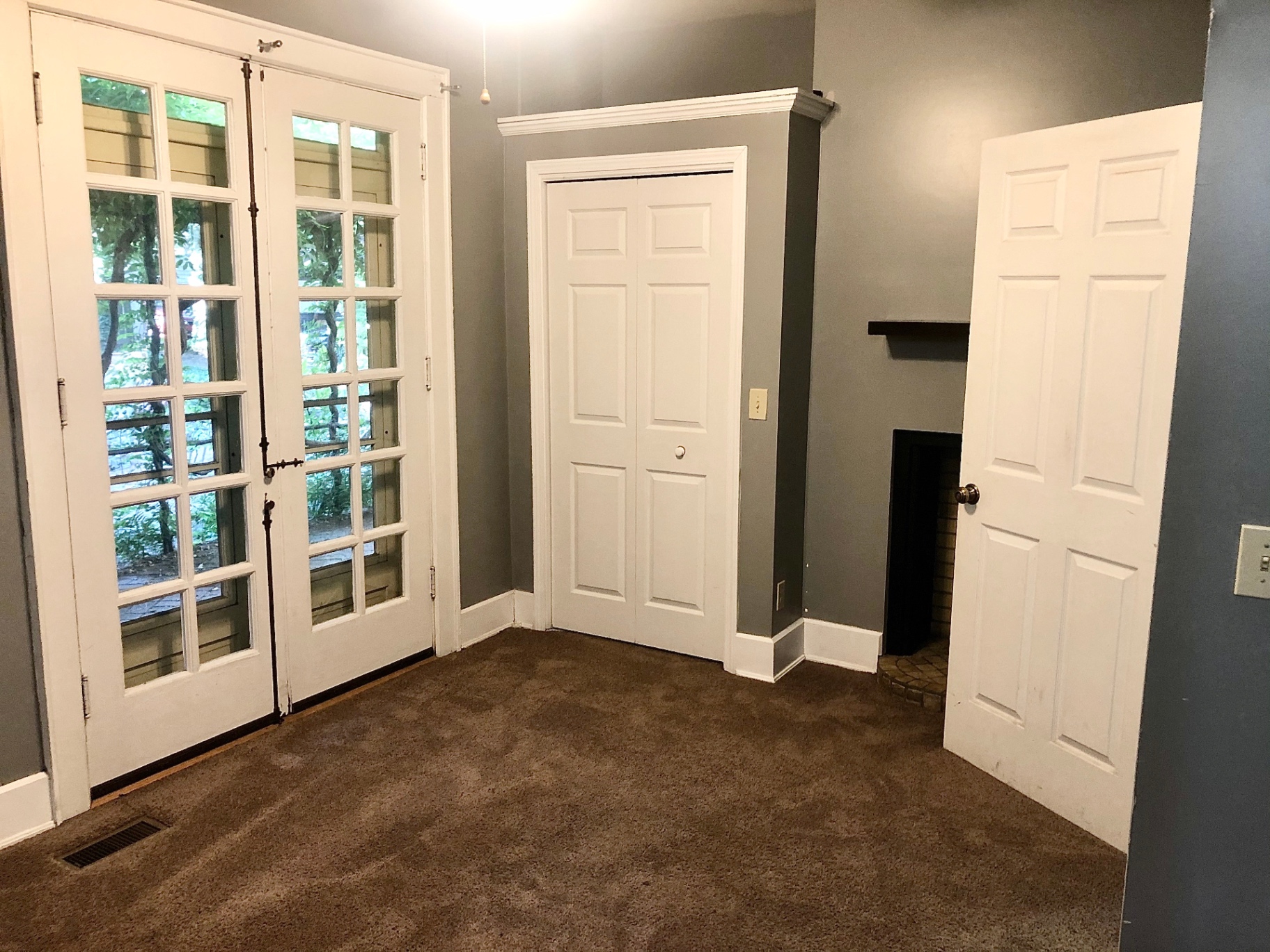 2034 Iuka Ave A bedroom with decorative fireplace and French doors to the porch