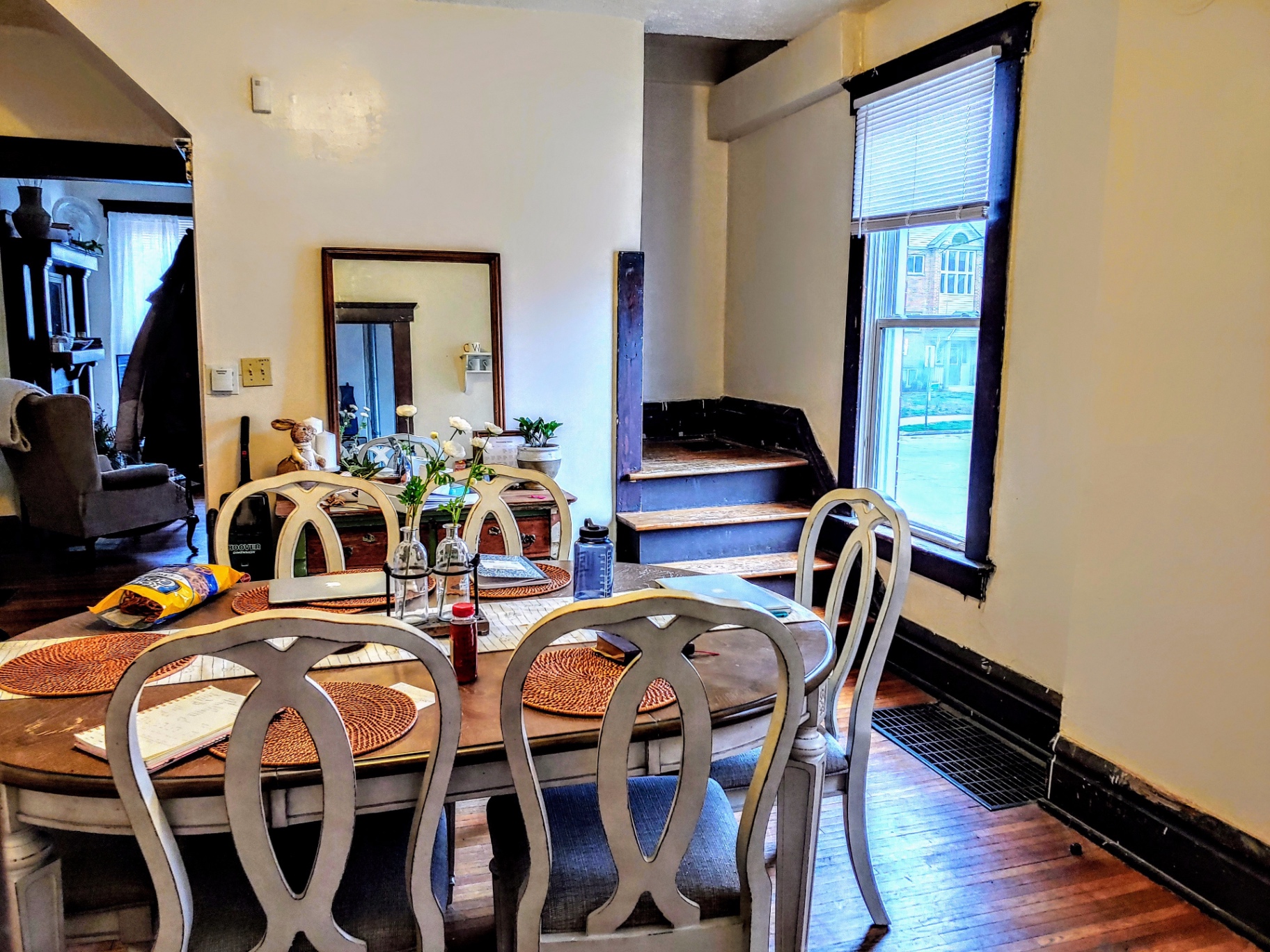 113 W 9th dining room with hardwood floors and stair landing