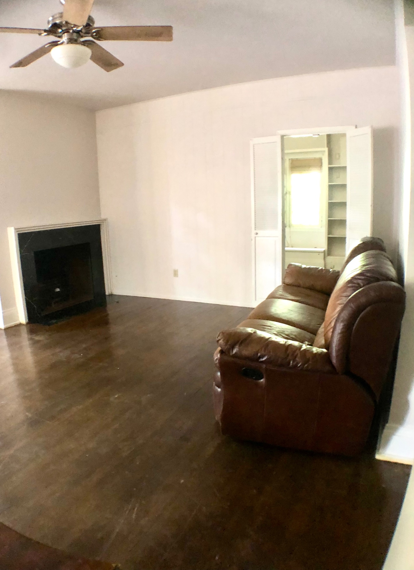 2026 Iuka Ave A living room with decorative fireplace, hardwood floors, and ceiling fan