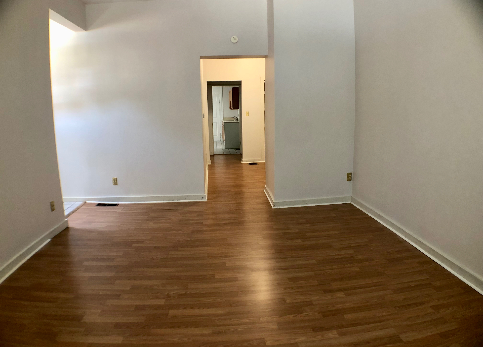 Unit A open living room looking down the hallway toward the kitchen