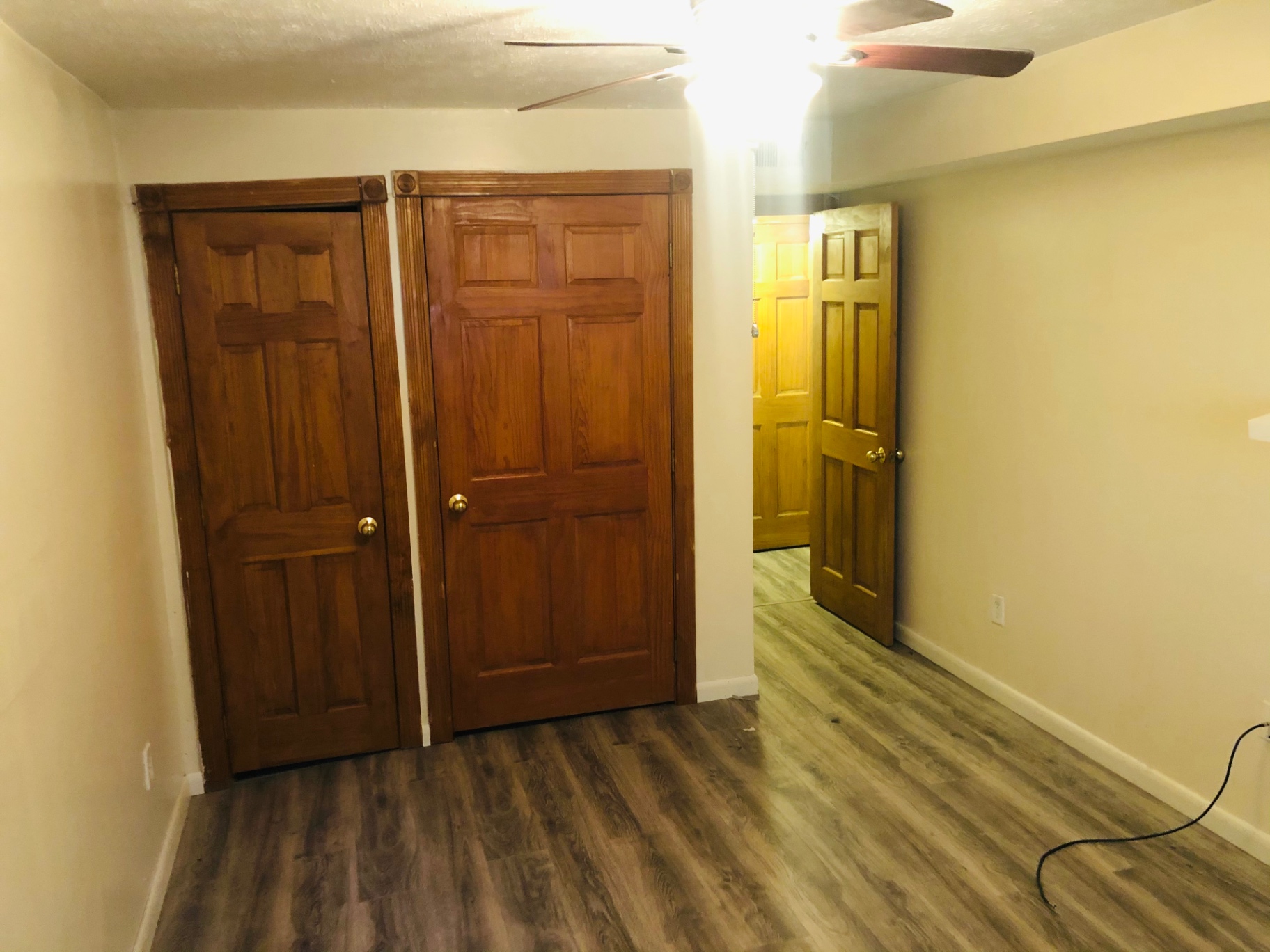 2150 N 4th St. Unit A bedroom with double wood closet doors and ceiling fan