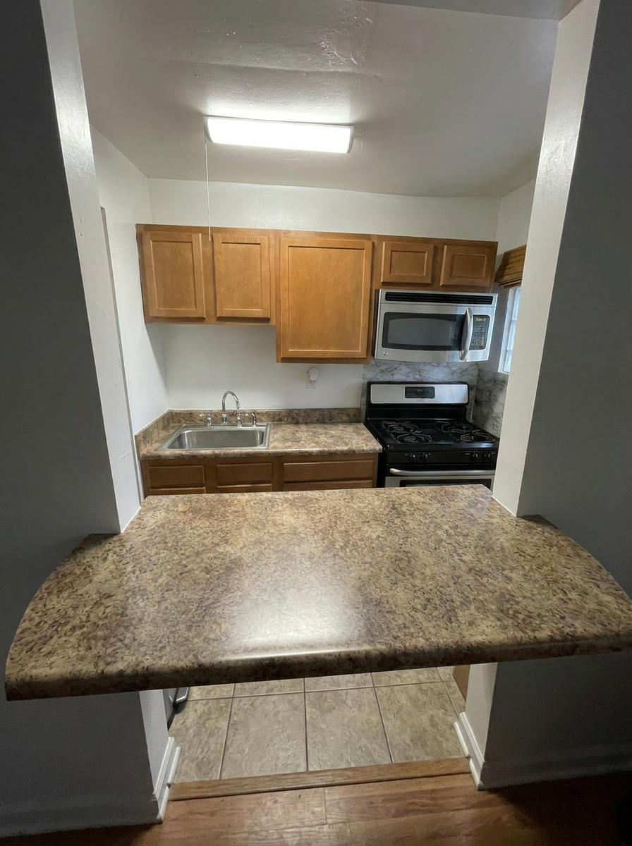 Unit M kitchen with breakfast bar counter and stainless steel appliances