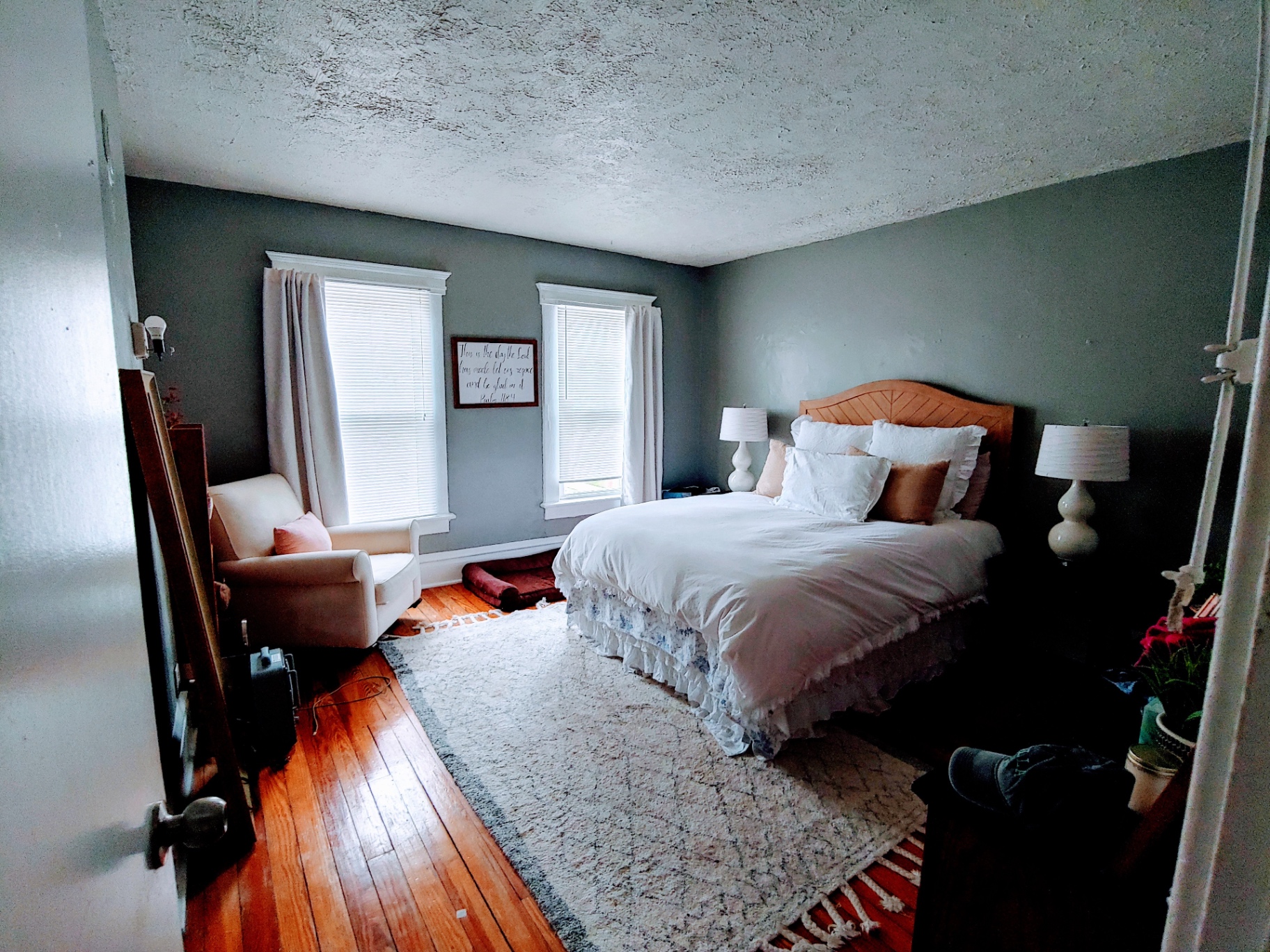 113 W 9th primary bedroom with hardwood floors and bright windows