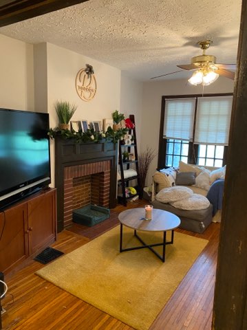 2155 N 4th St. living room with fireplace mantel, TV, and area rug