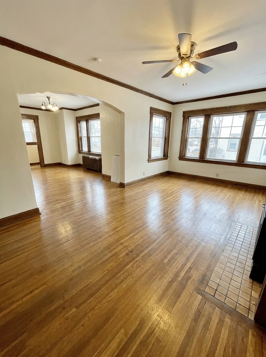 Unit D expansive living room with hardwood floors and dining area beyond