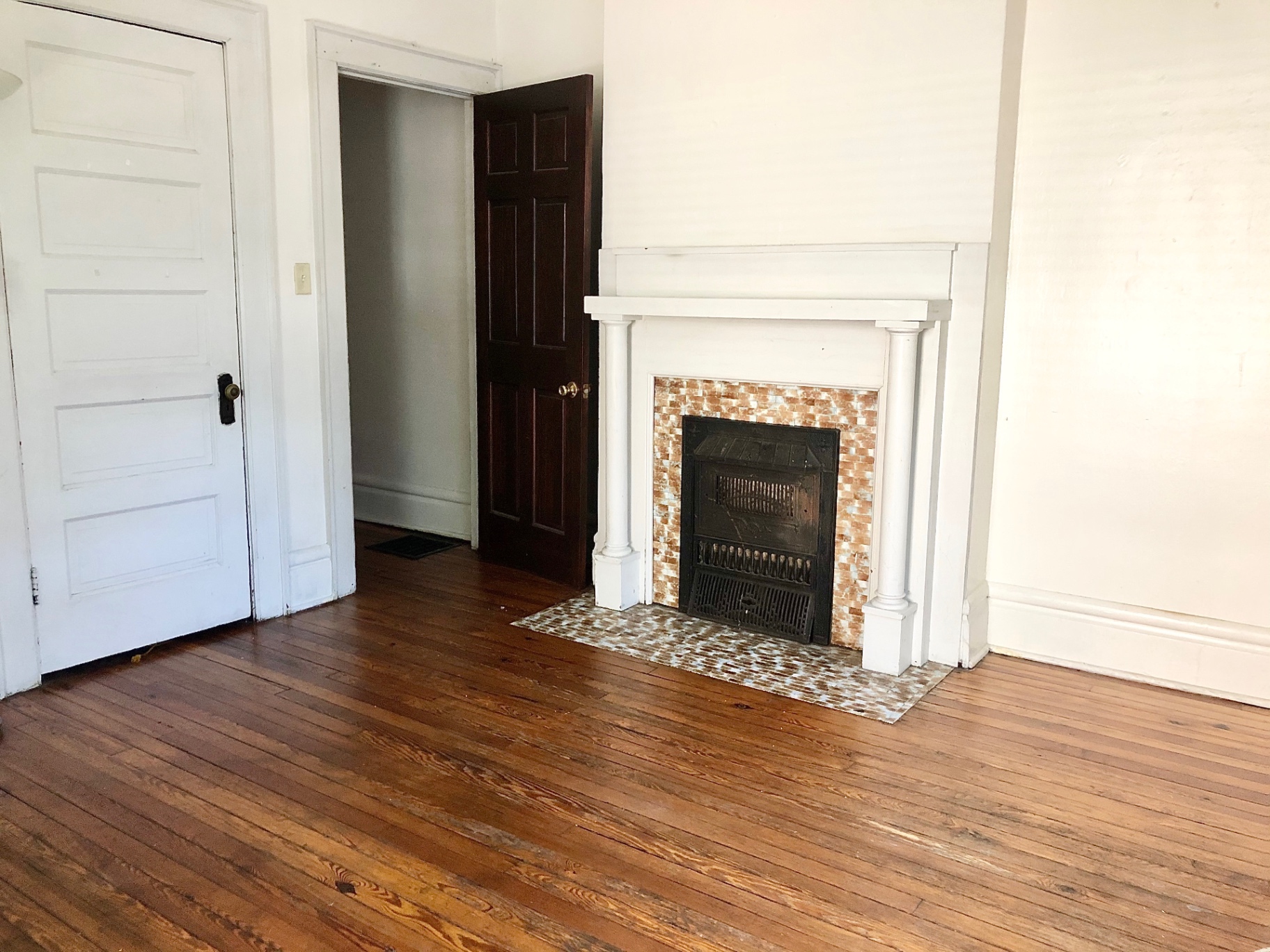 372 B E 14th Ave. living room with decorative tile fireplace, white mantel, and hardwood floors