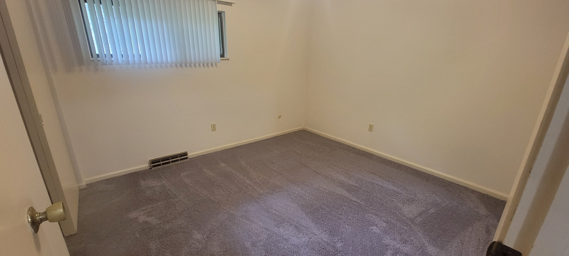 2022 Iuka Ave. carpeted bedroom with wide window and vertical blinds