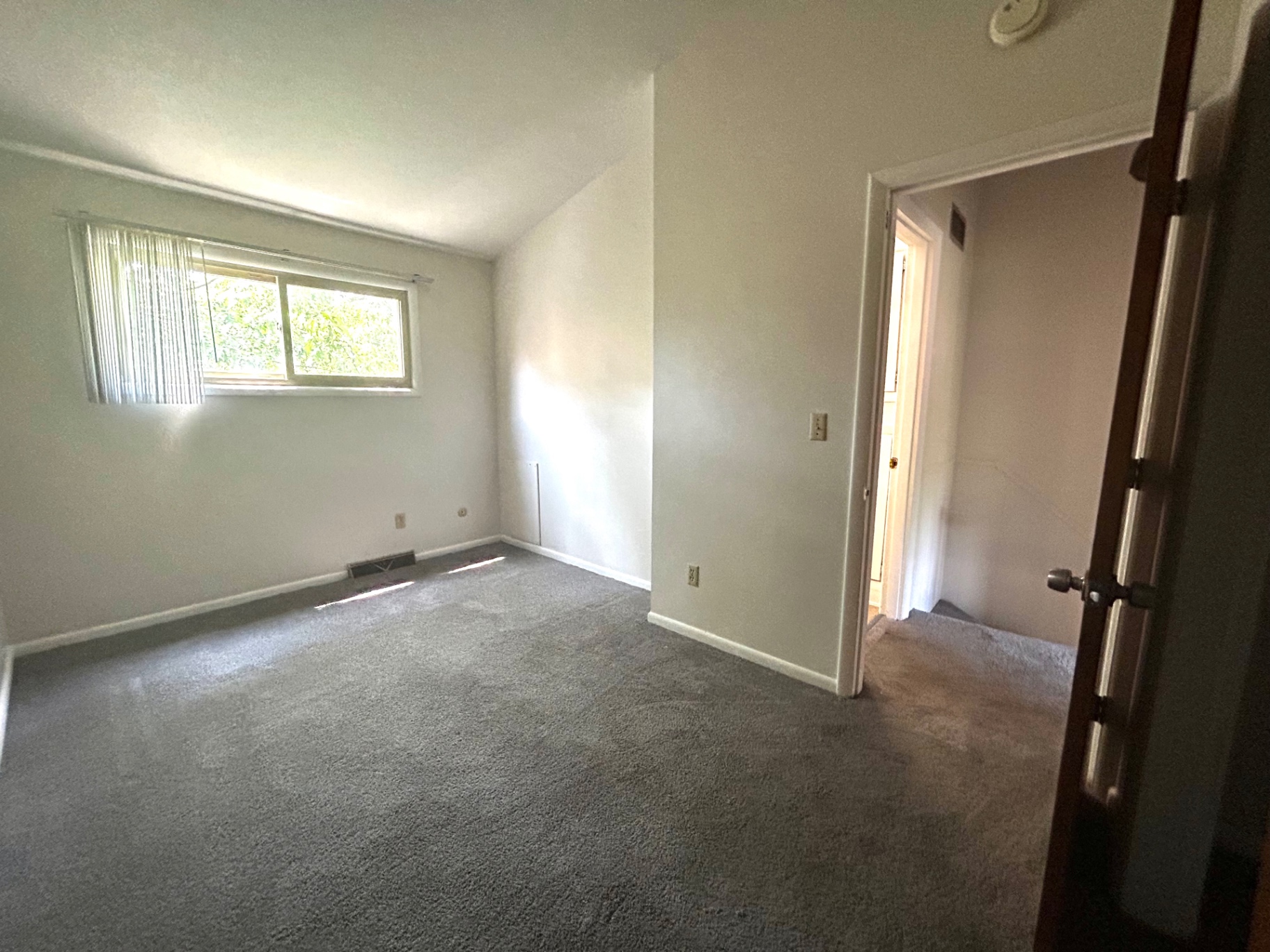 2011 Summit St. Unit E second bedroom with broad window and clean neutral walls