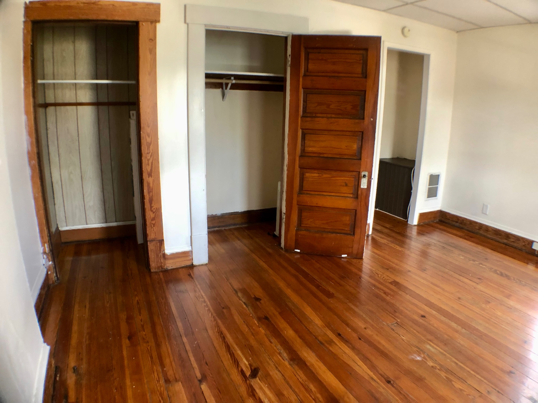 89 E Woodruff Ave. Unit A open closet with hanging rod and hardwood floors