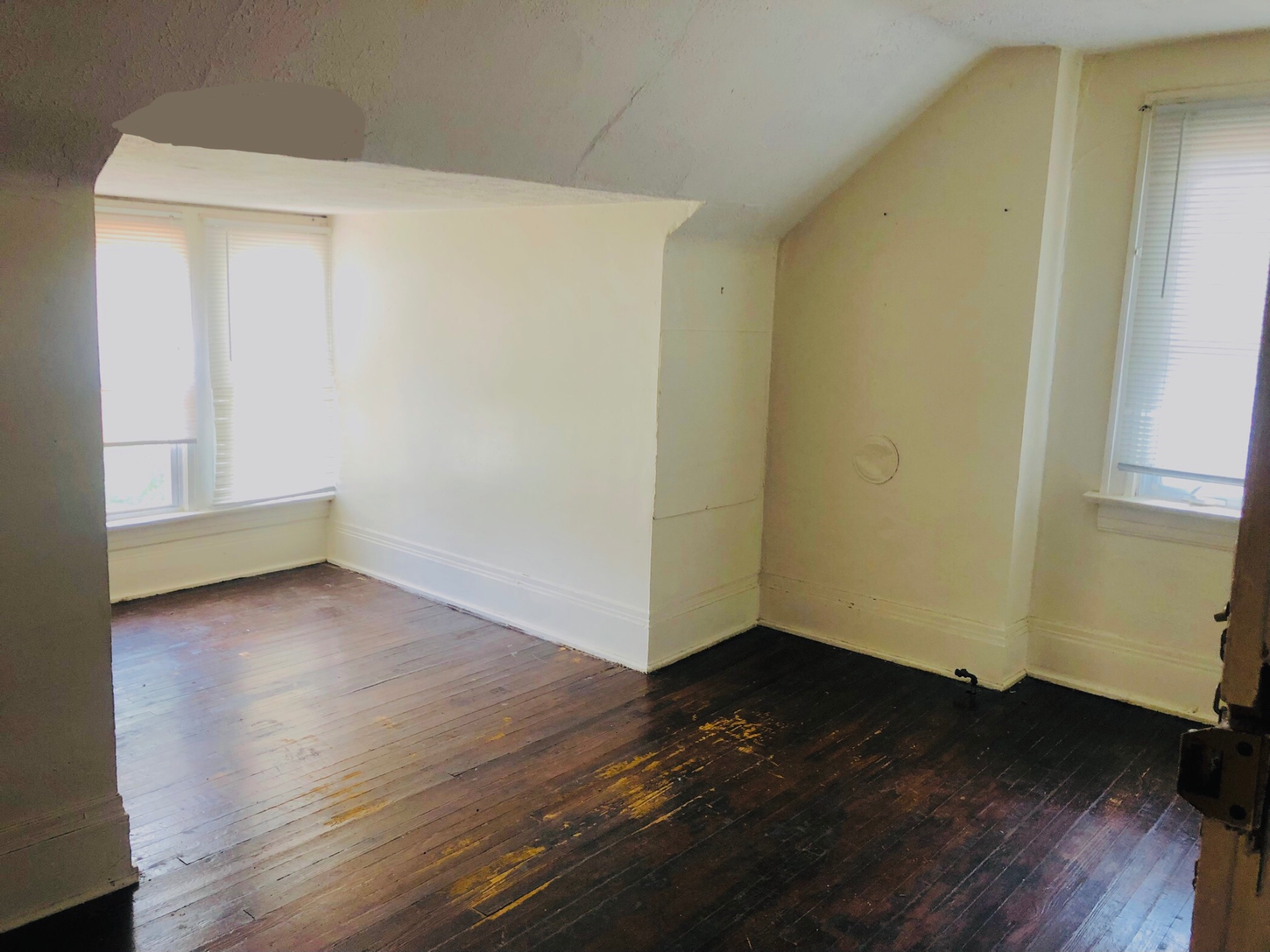 2005 Summit St. upstairs bedroom with vaulted ceiling, hardwood floors, and bright windows