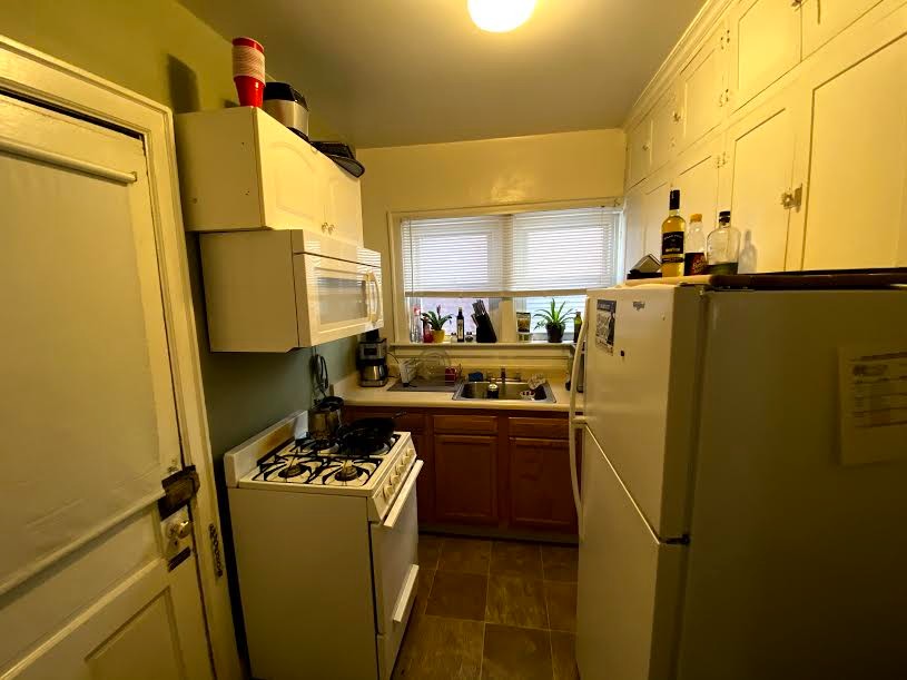 2054 Iuka Ave. B kitchen with gas range, microwave, full-size fridge, and abundant cabinetry