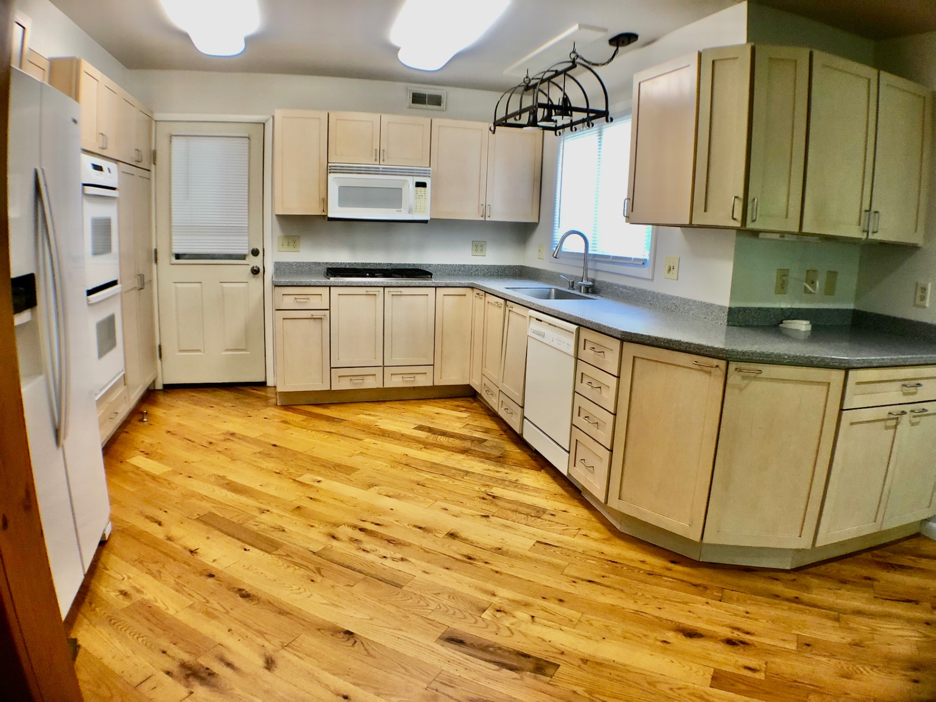 2040 Iuka Ave House wide kitchen view with gas cooktop, dishwasher, and hanging pot rack