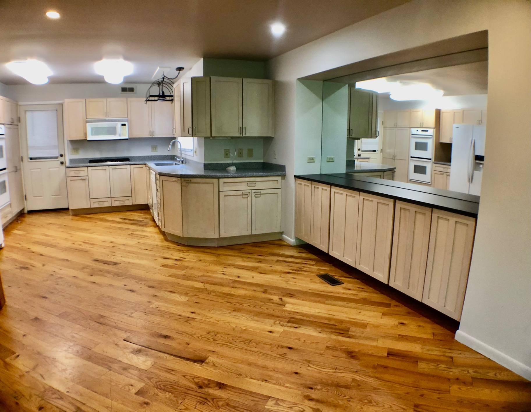 2040 Iuka Ave House kitchen with pass-through opening to dining and hardwood floors