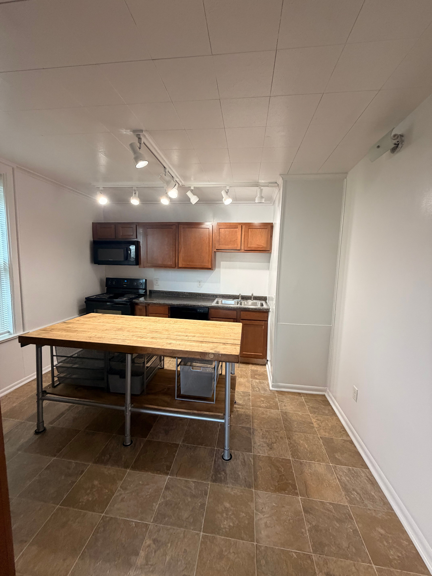 3340 Chestnut Upstairs kitchen with butcher-block island, black appliances and double sink