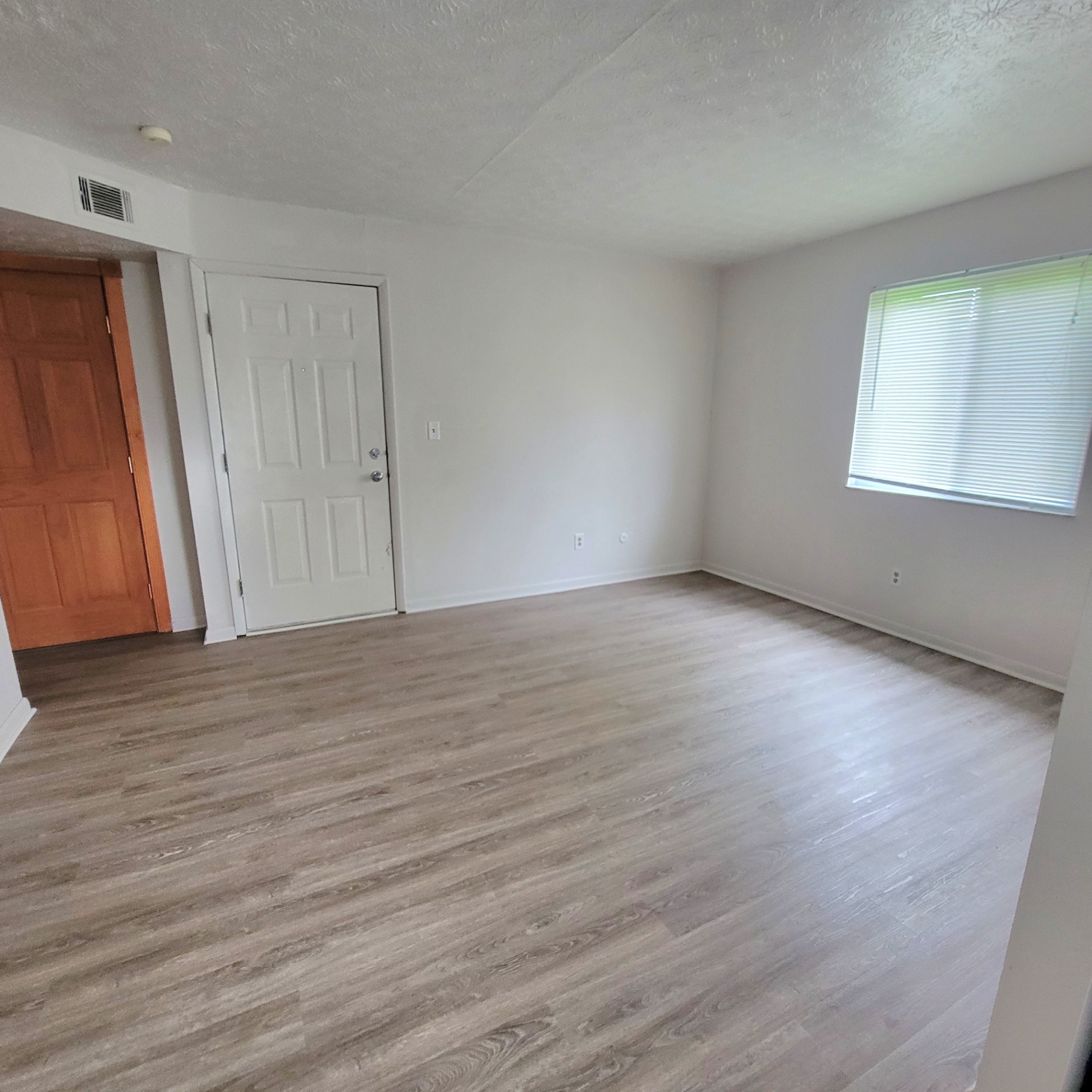 2150 N 4th St. Unit D entry and living area with plank flooring and bright window