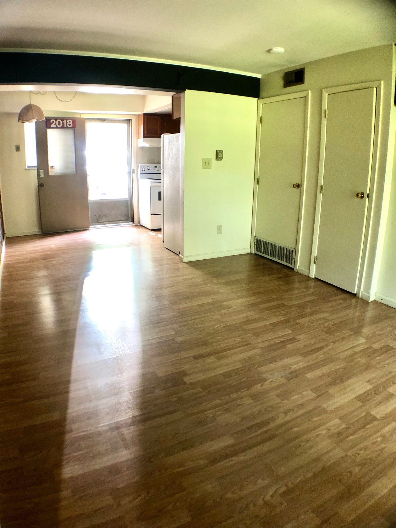 2018 Iuka Ave. open living room with wood floors, staircase, and view into the kitchen