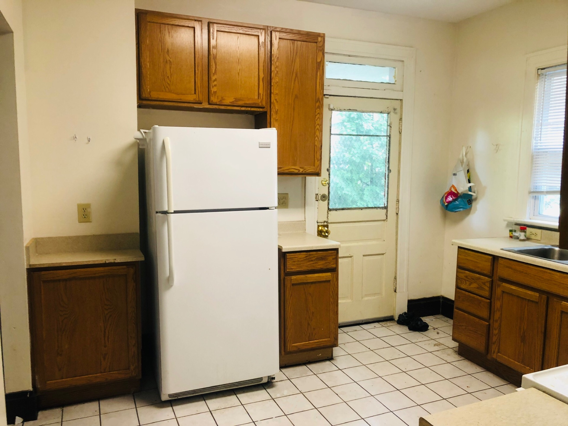 2005 Summit St. kitchen with oak cabinets, tile floor, and rear entry door