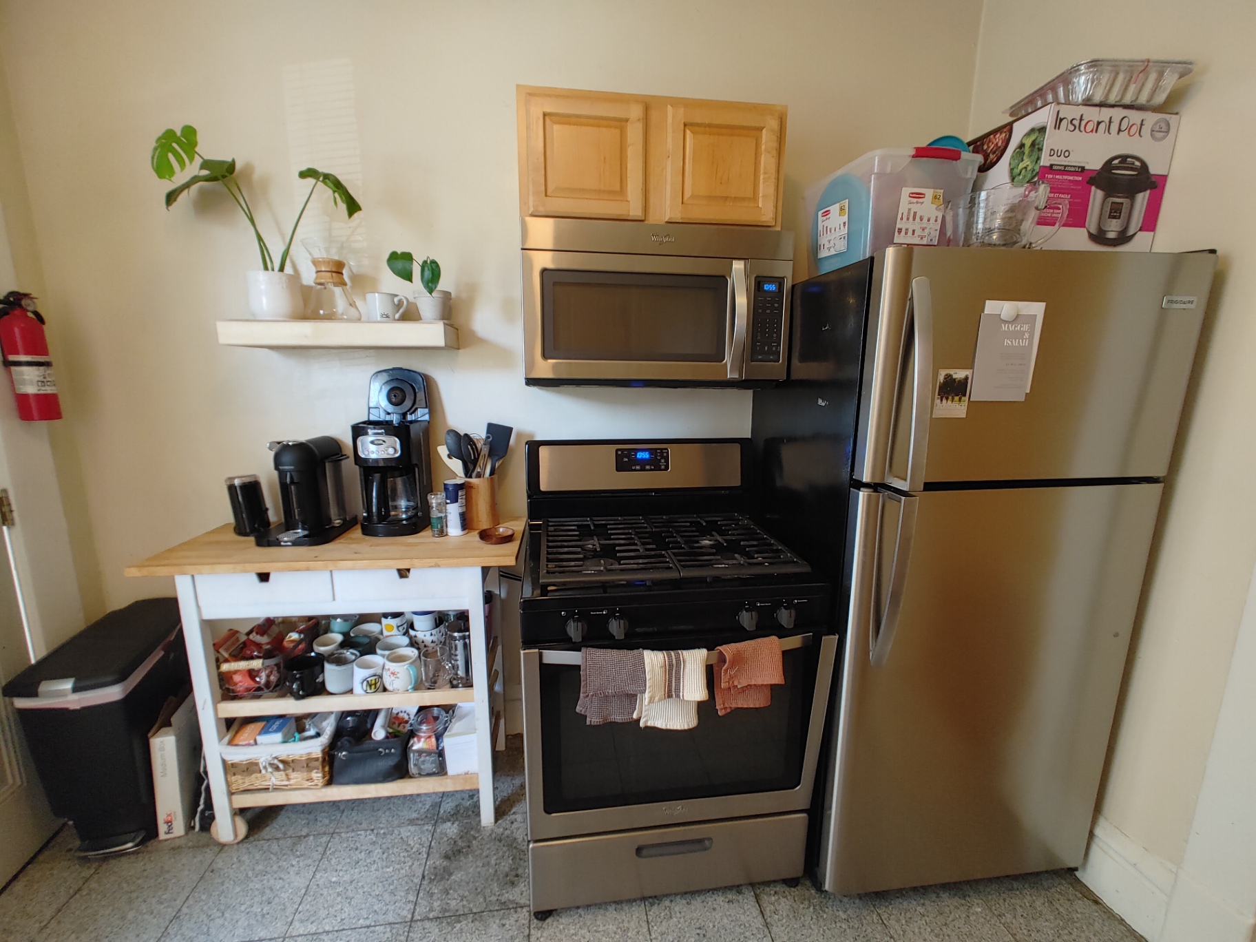 121 W 9th kitchen with stainless gas range, microwave, and refrigerator