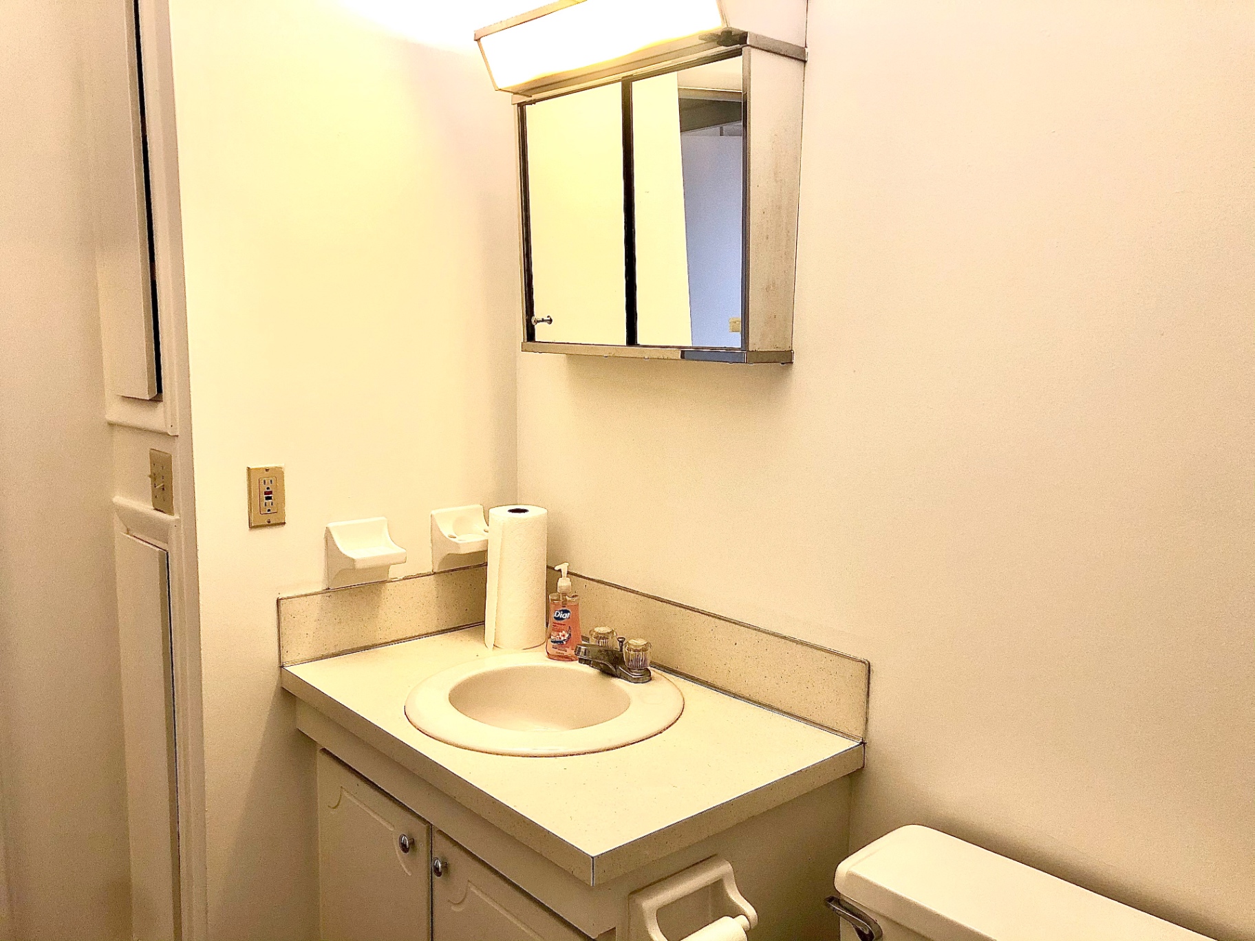 2011 Summit St. Unit B half bath with vanity and medicine cabinet