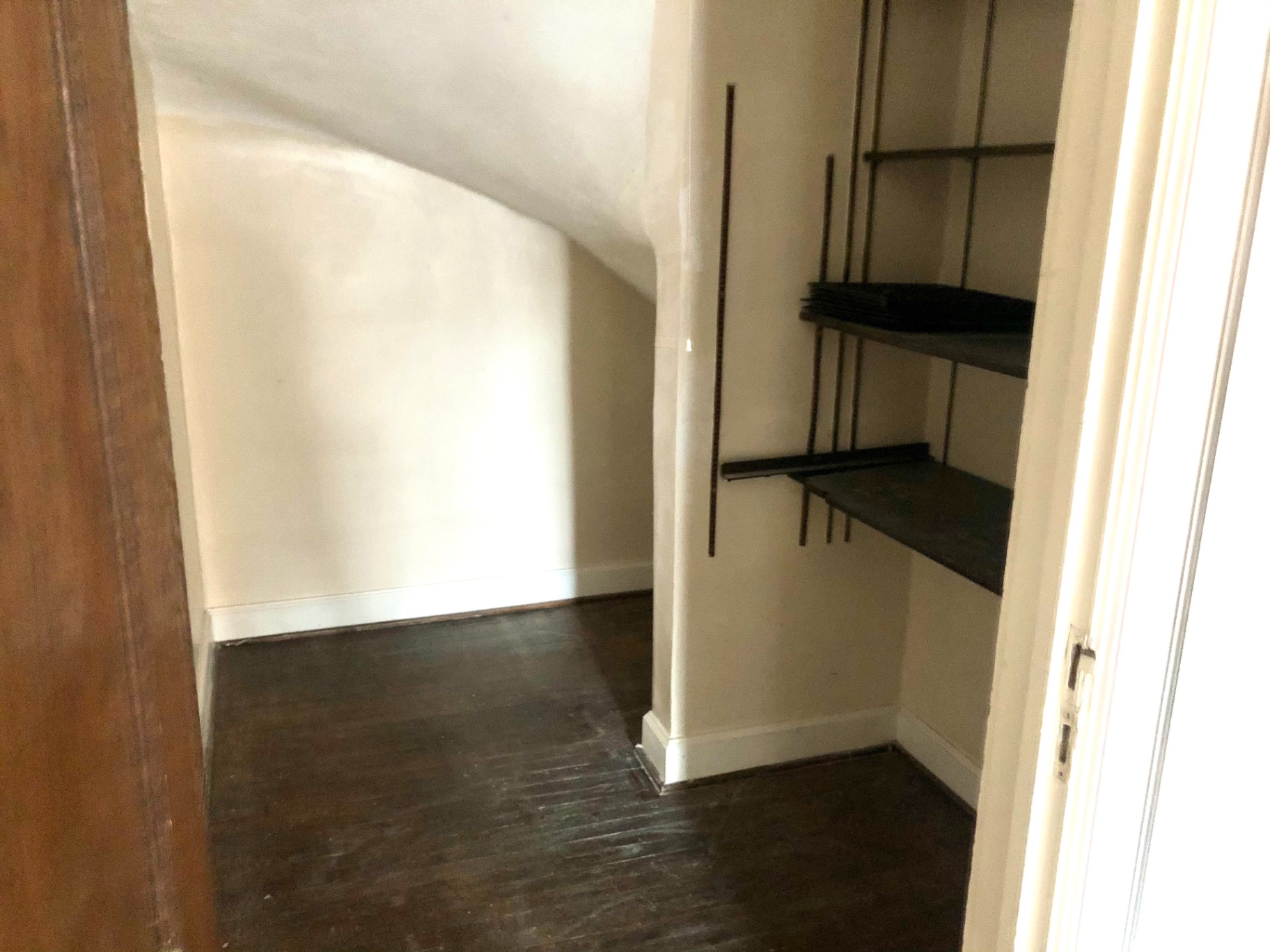 2044 Iuka Ave. B bonus storage nook with built-in wood shelving under a sloped ceiling
