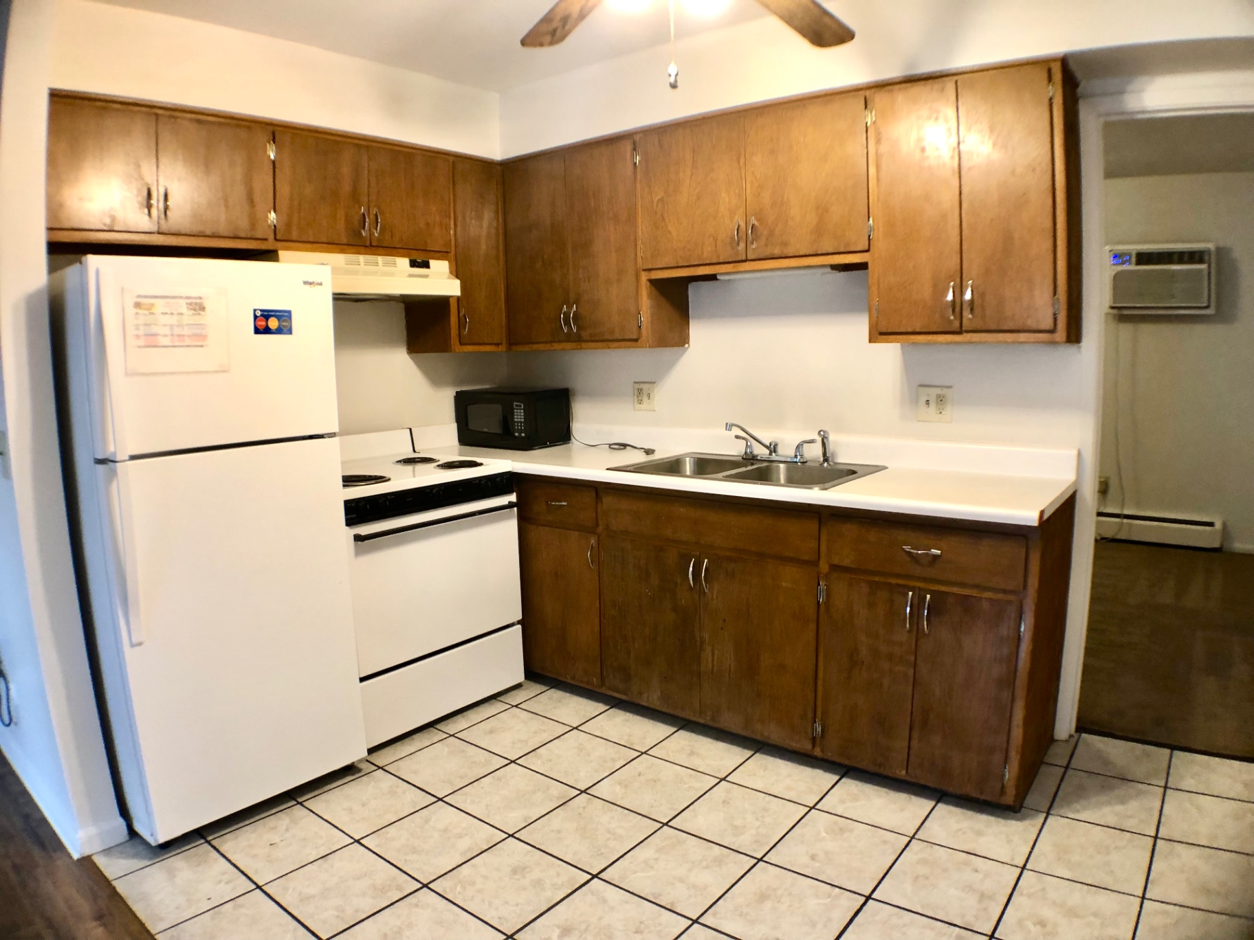 1827 N 4th St. Unit 4 kitchen with oak cabinets, white fridge, electric range, and tile floor