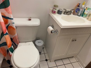 1827 N 4th St. Unit 7 bathroom with white vanity and tiled tub surround