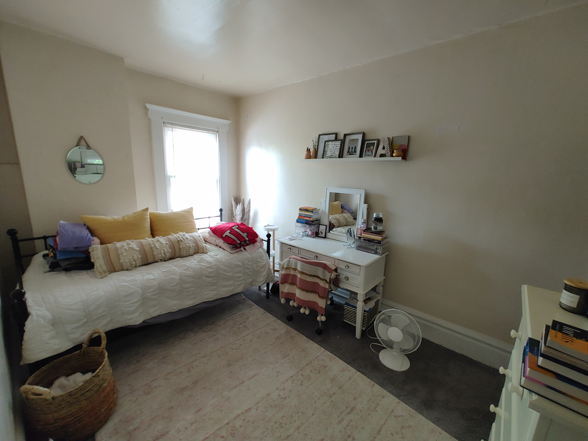 121 W 9th second bedroom with daybed, area rug, and vanity