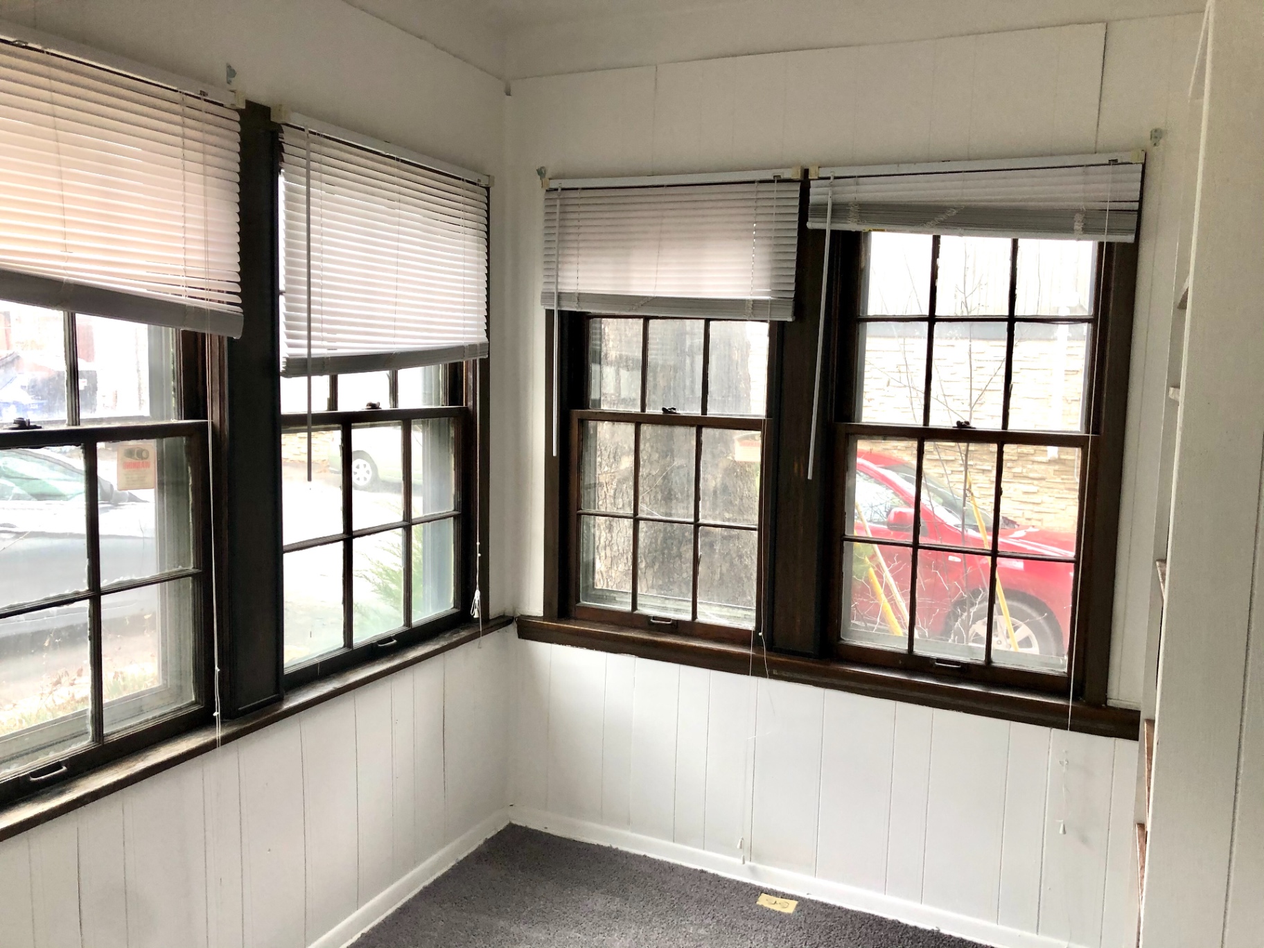 2044 Iuka Ave. B enclosed sunroom with wraparound wood-trim windows and street views