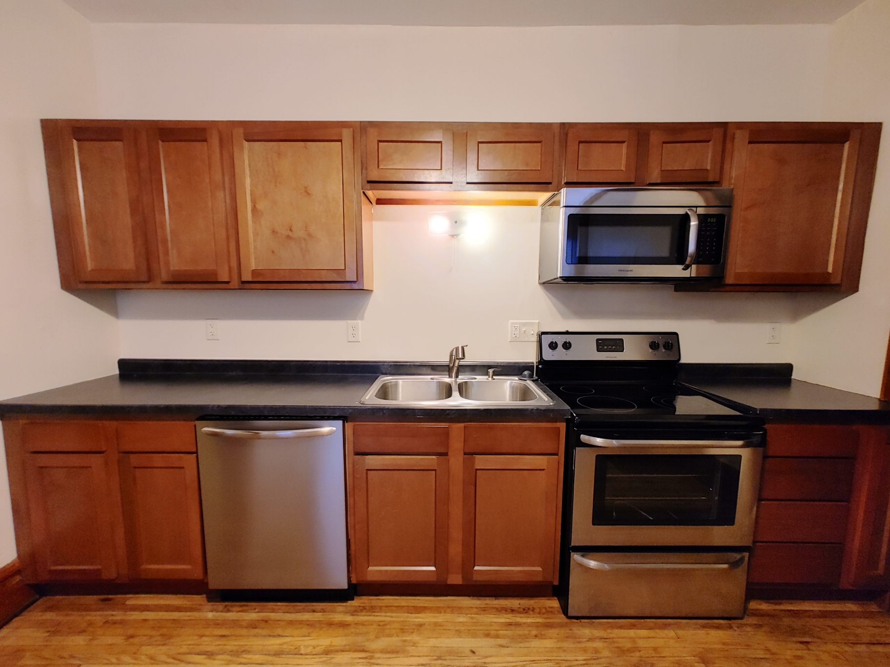 374 A E 14th Ave. kitchen with maple cabinets, stainless microwave, range, and double sink
