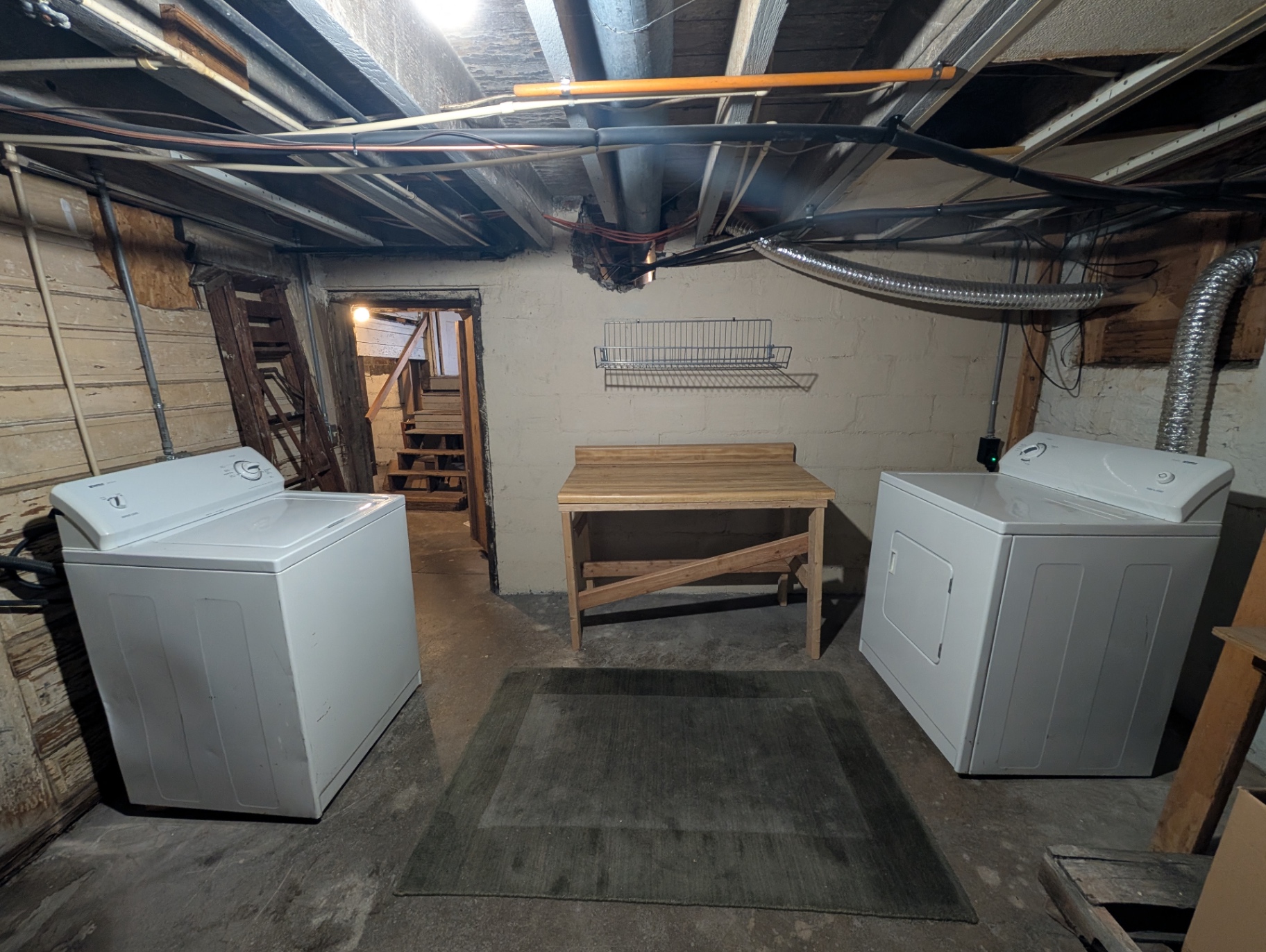 3338 Chestnut shared basement laundry room with washer, dryer and folding table