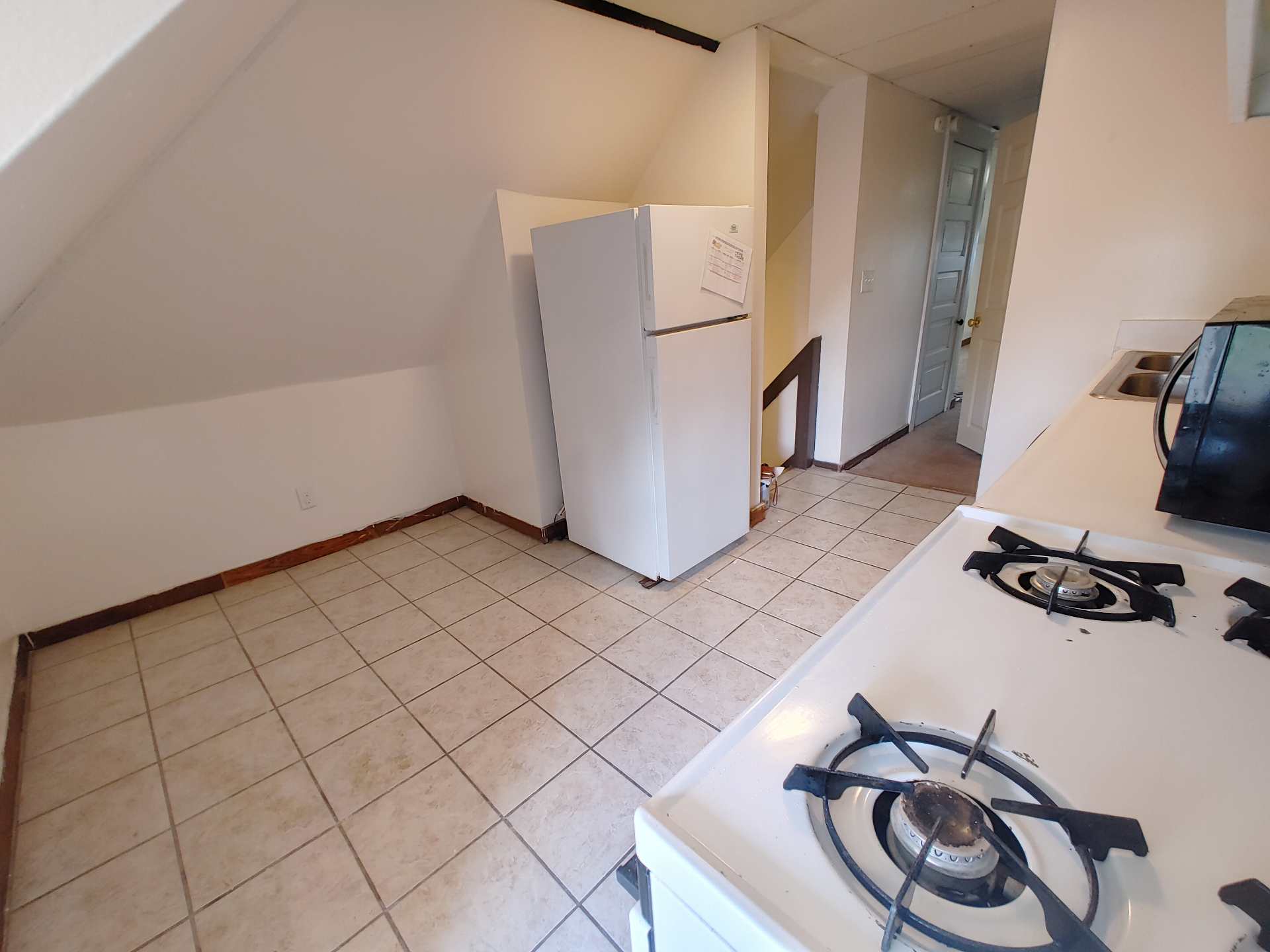 89 E Woodruff Ave. Unit C eat-in kitchen with tile floor, full-size fridge, and gas range