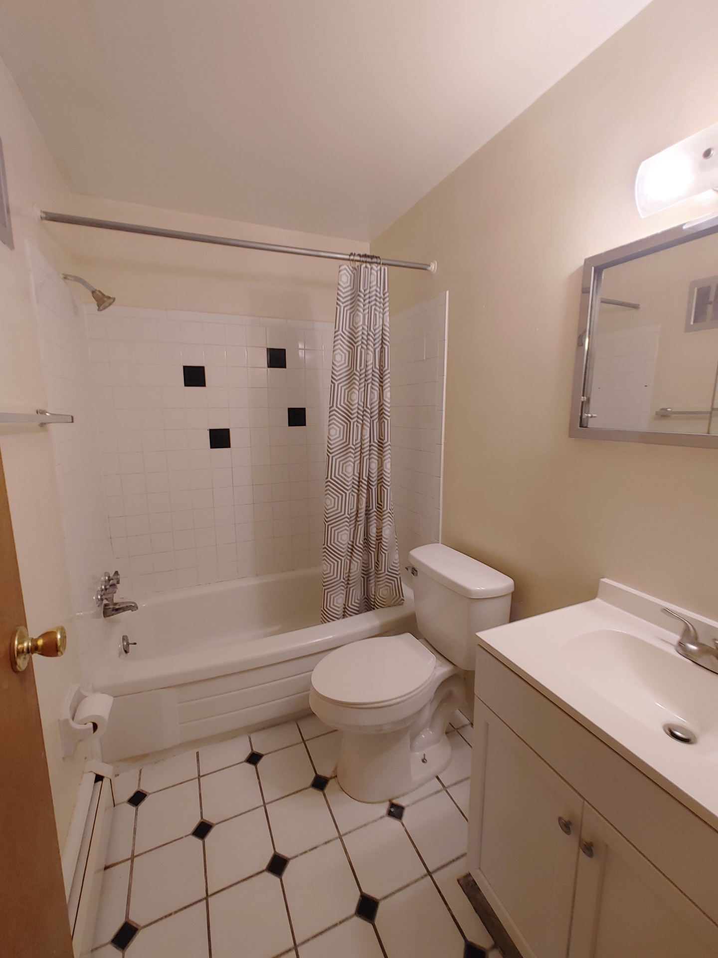 1827 N 4th St. Unit 3 bathroom with tub shower, white vanity, and tile floor