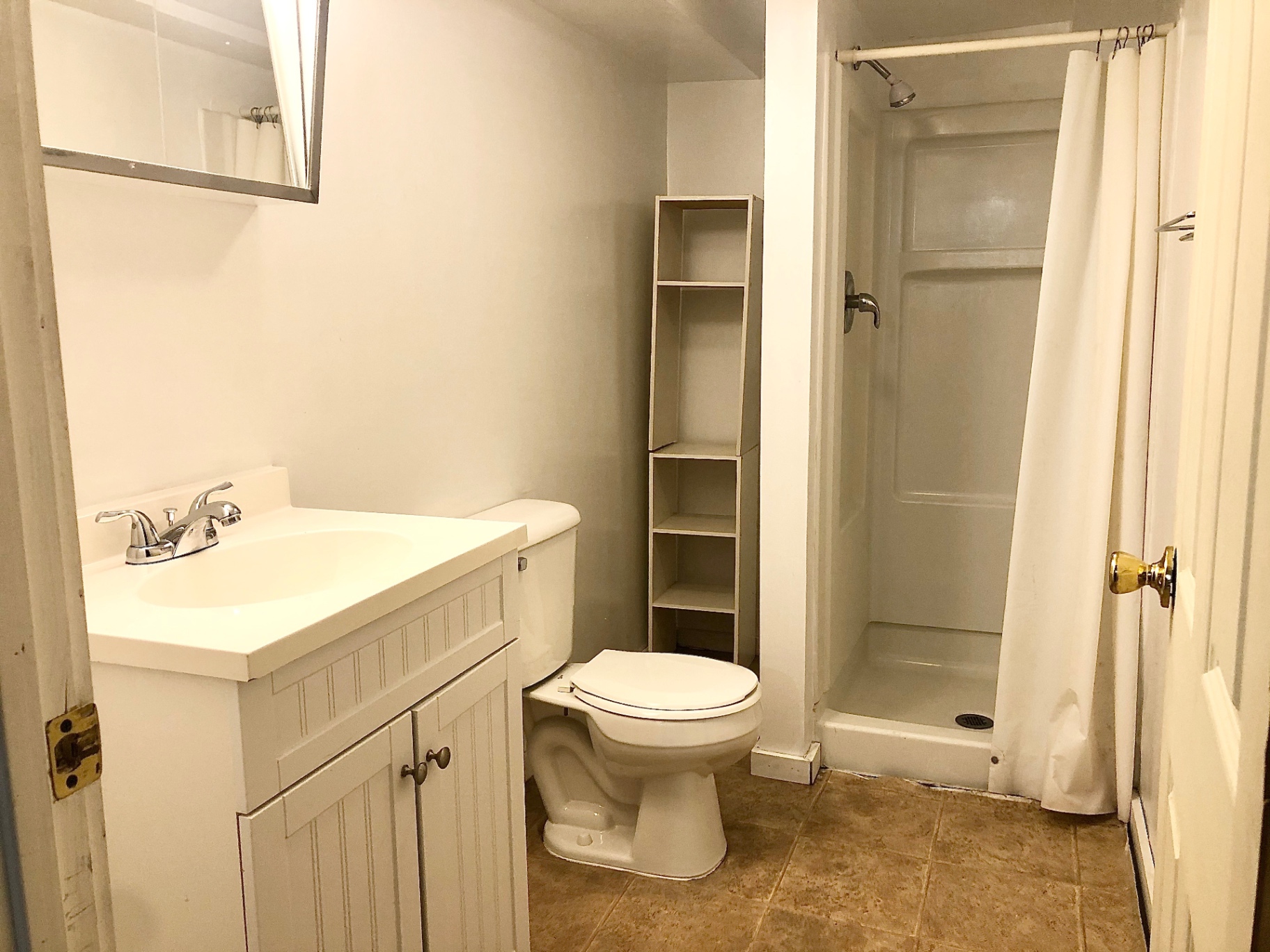 2015 Summit St. bathroom with white vanity, toilet, and stand-up shower