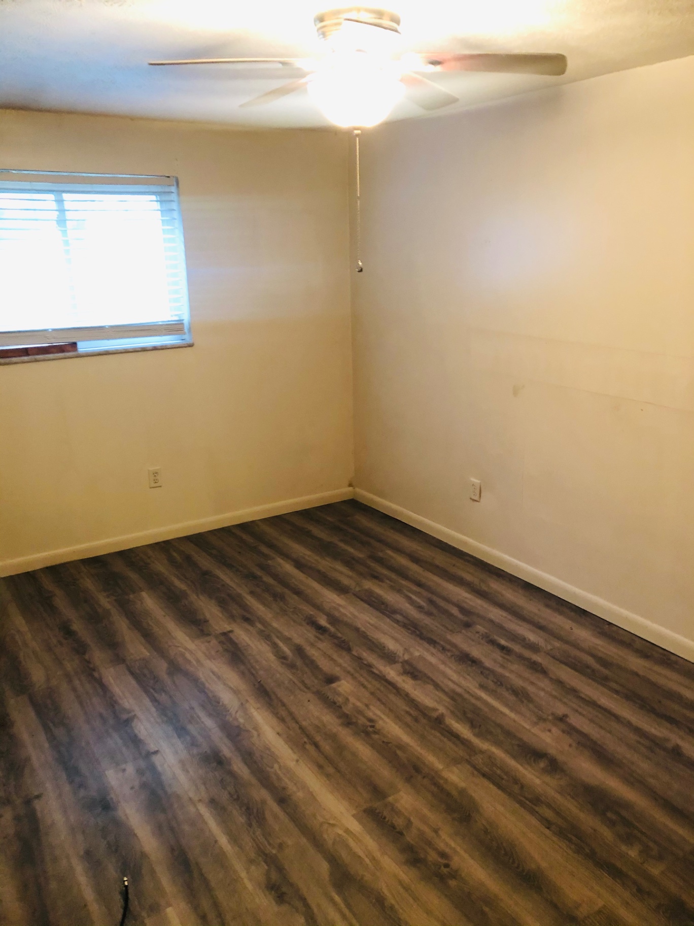 2150 N 4th St. Unit A bedroom with ceiling fan and wood-look flooring