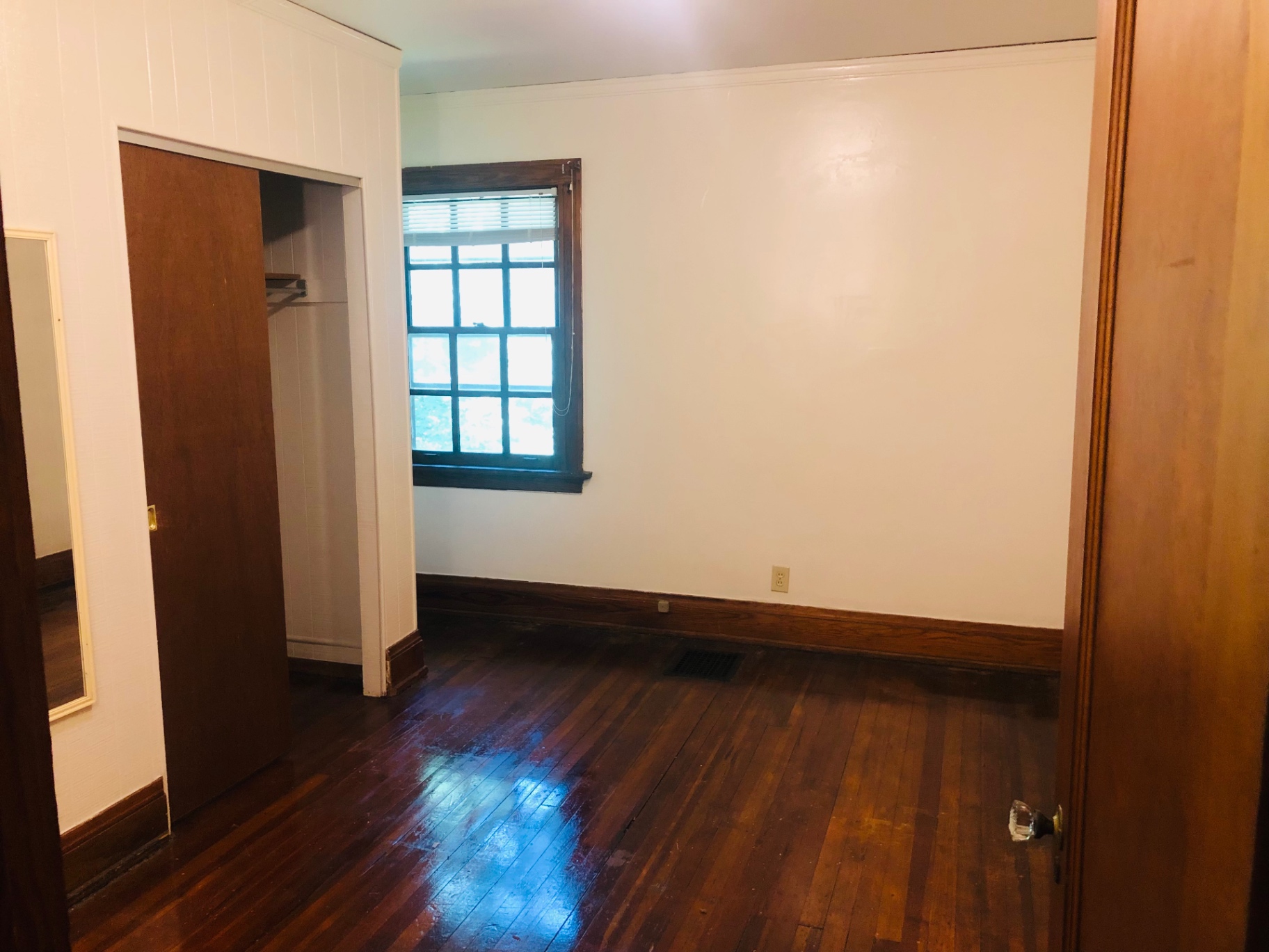 2026 Iuka Ave C bedroom with hardwood floors, large closet, and bright window