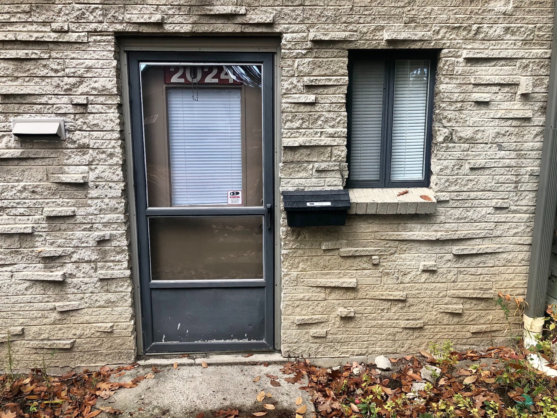 2024 Iuka Ave private front entry on stone-brick facade