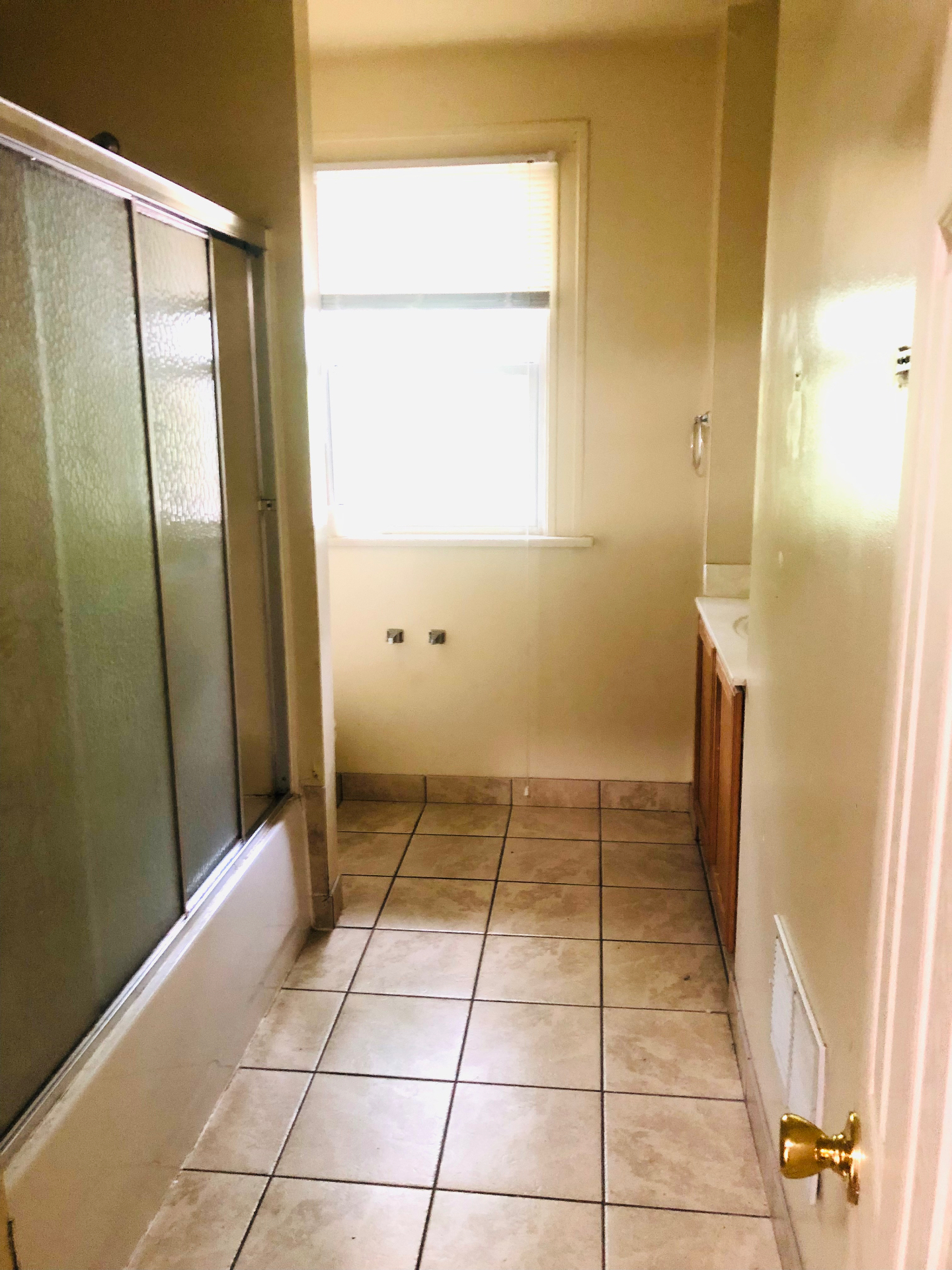 2005 Summit St. bathroom with tiled floor, glass shower doors, and vanity